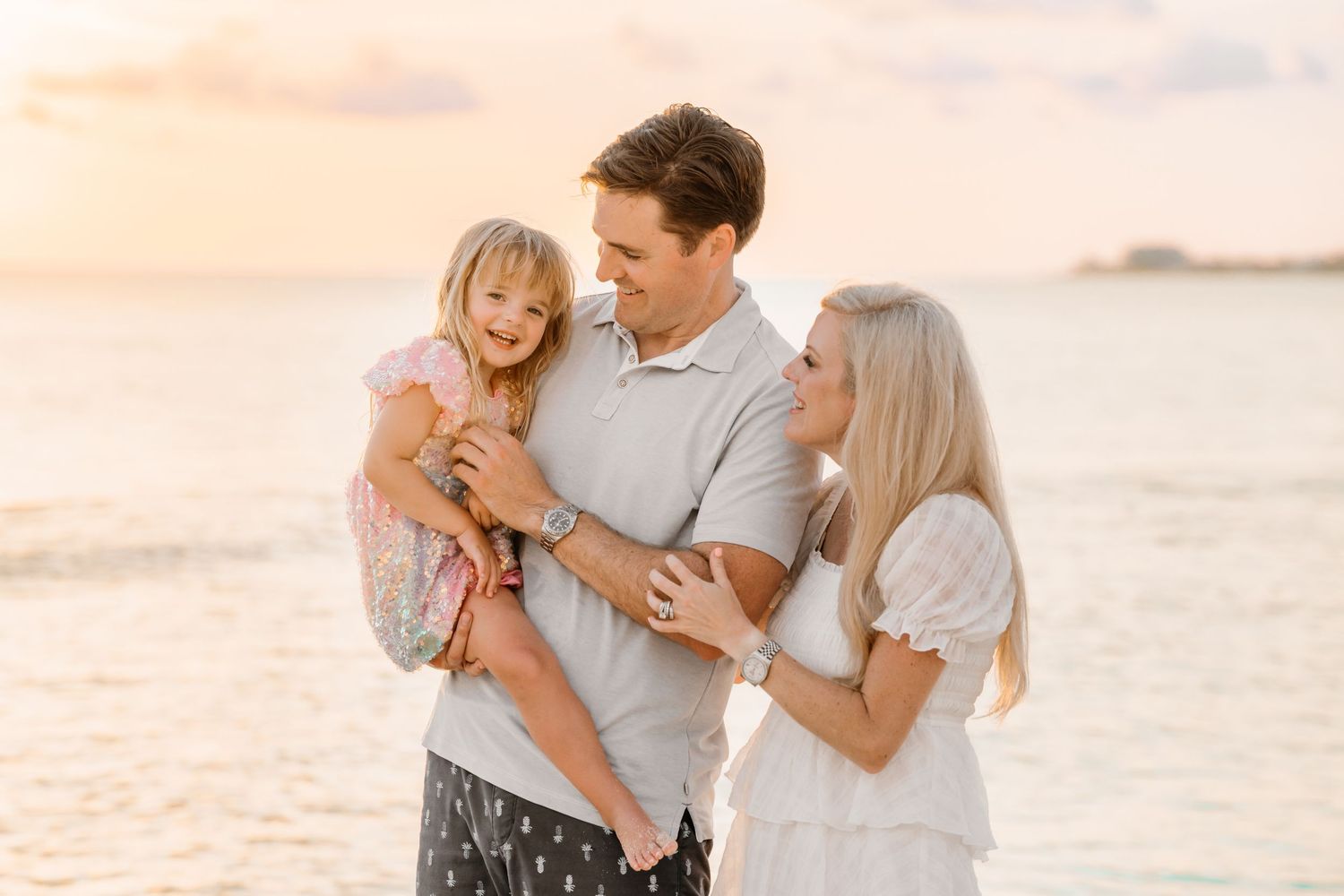 Sweet family interactions during a golden hour beach photoshoot.