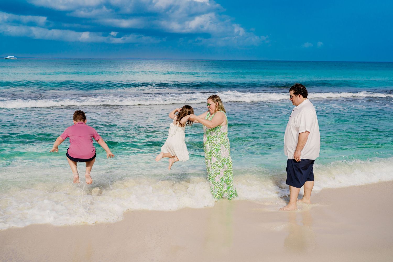 Candid beach moments captured as waves crash near people playing in the shallow water.