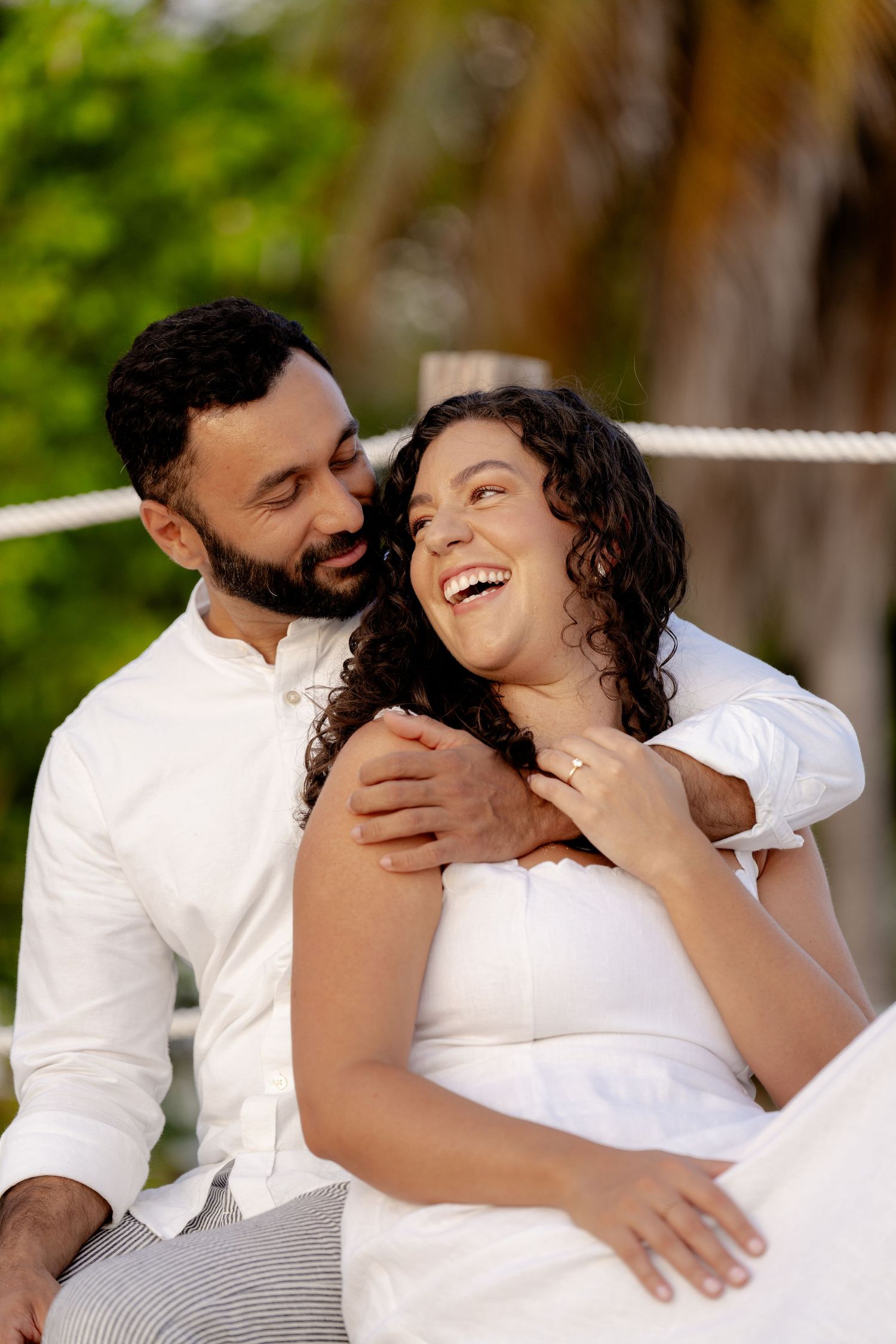 Romantic couple in white outfits sharing intimate moments in a sequence of photos.