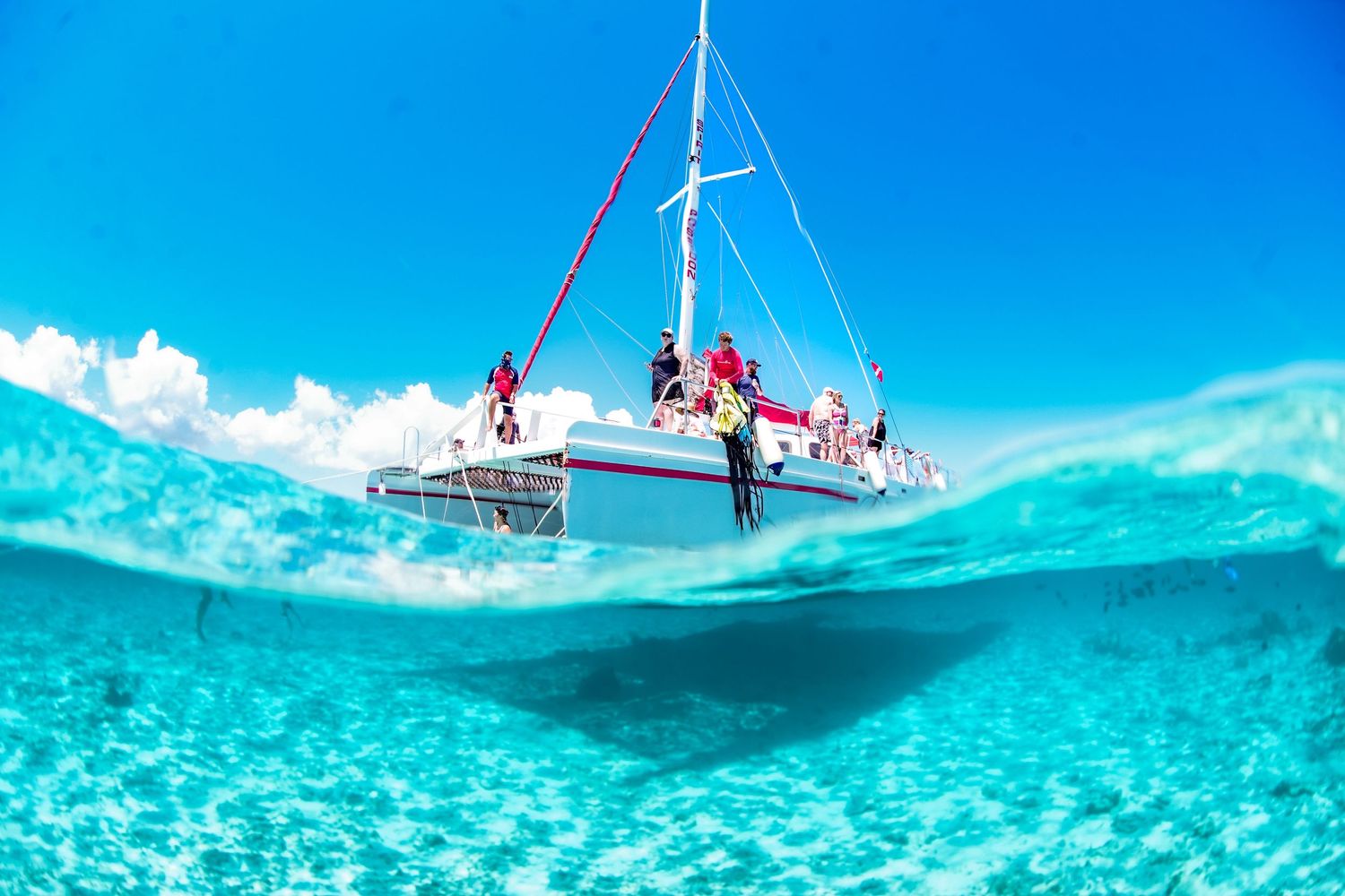 Split view of sailboat anchored in crystal clear tropical waters.