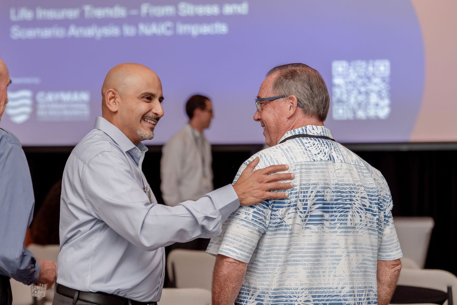 Presenters engaged in discussion during a professional conference session.