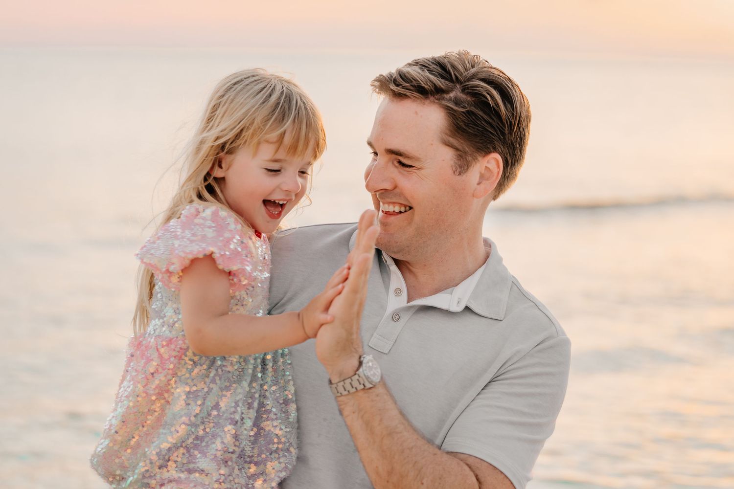 Intimate family portraits captured during golden hour on a peaceful beach.