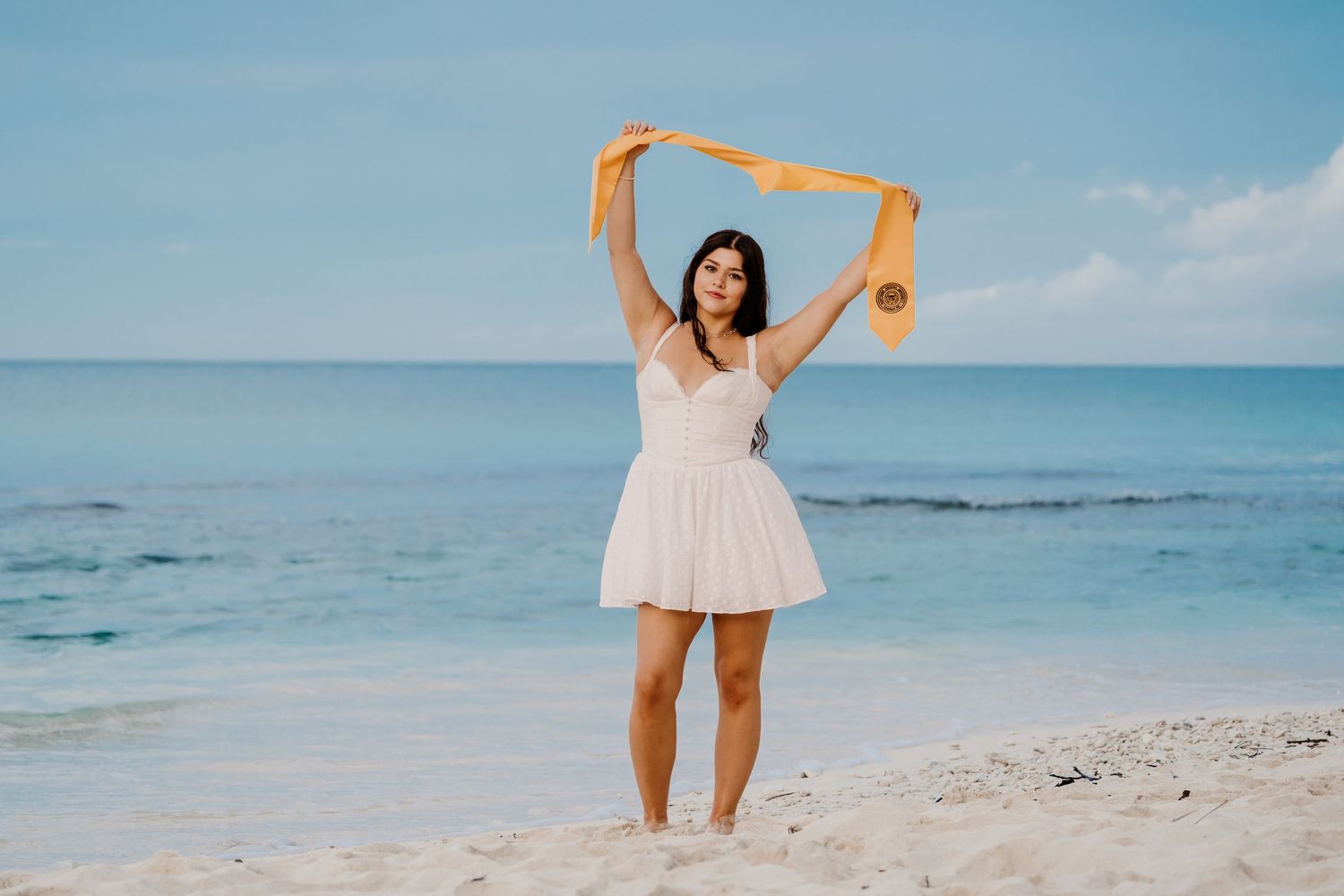 Playful beach scene with orange prop against blue ocean horizon.