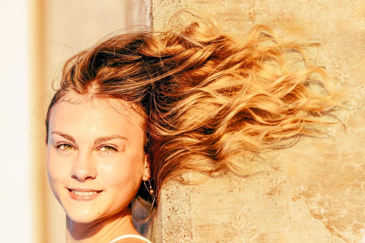 Artistic sequence of profile shots with hair flowing in warm lighting.