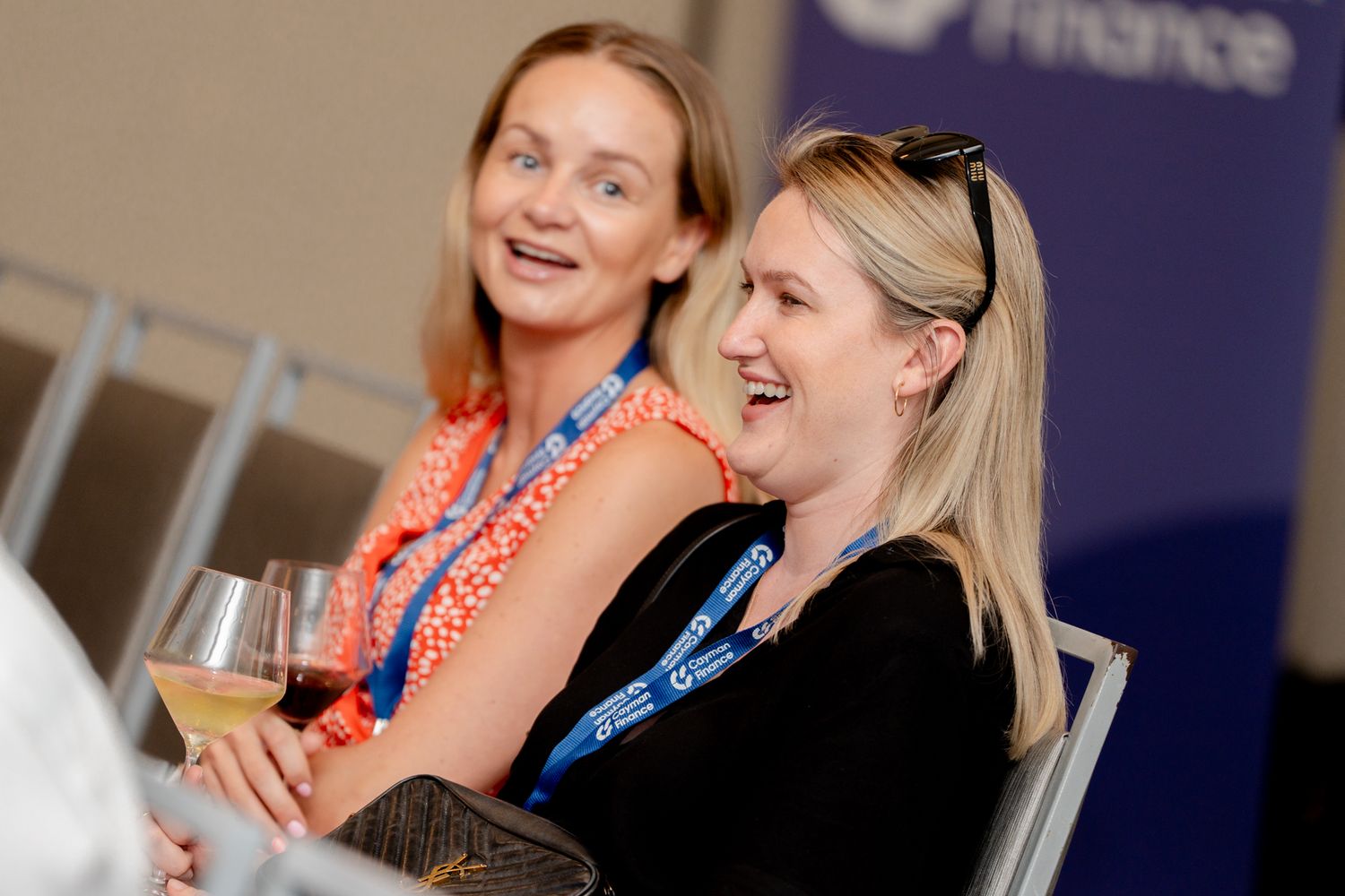 Attendees sharing a lighthearted moment during a professional conference.