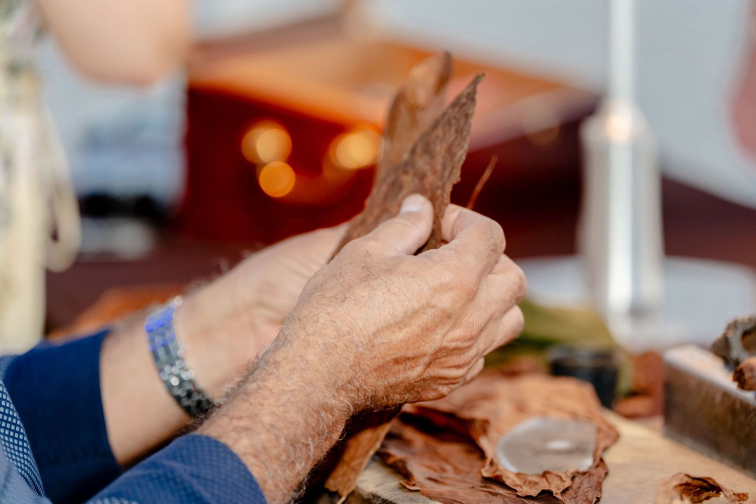 Hands reaching for food at a party table.