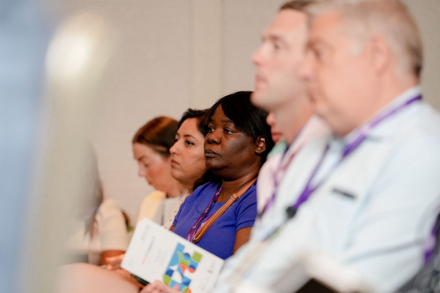 Conference attendees seated in rows during a professional presentation.