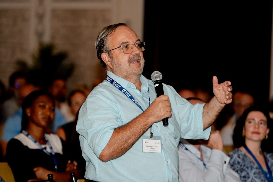 Speaker engaging with audience during Q&A session at professional conference.