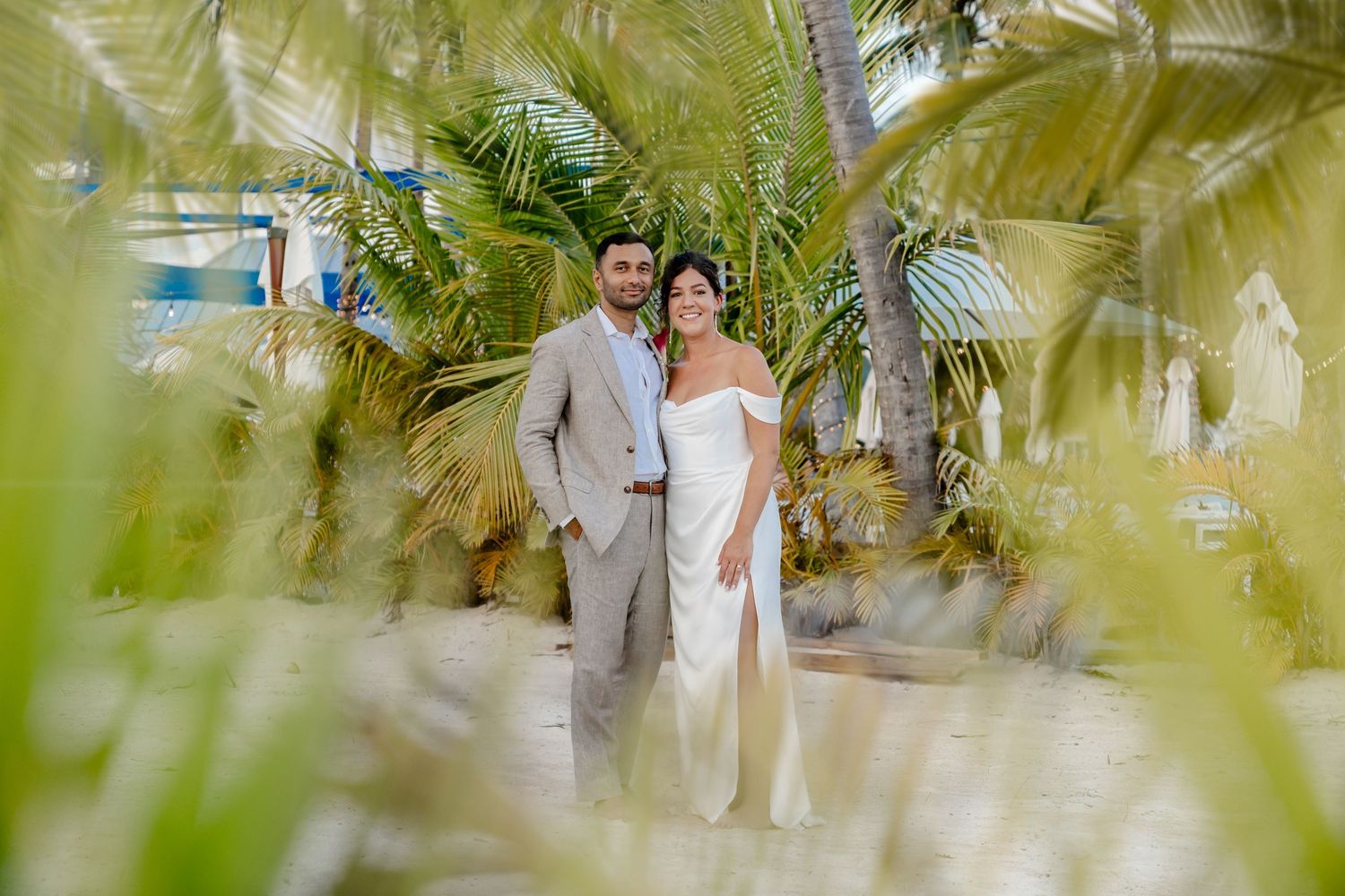 Romantic photoshoot in a lush tropical garden with palm trees.