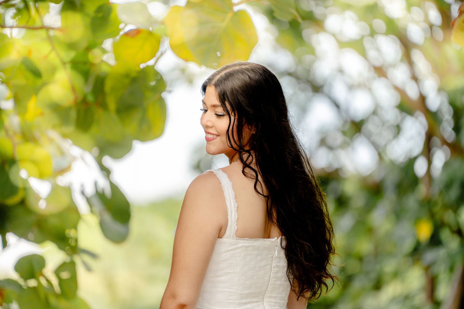 Side profile portraits in natural garden setting with soft lighting and greenery.