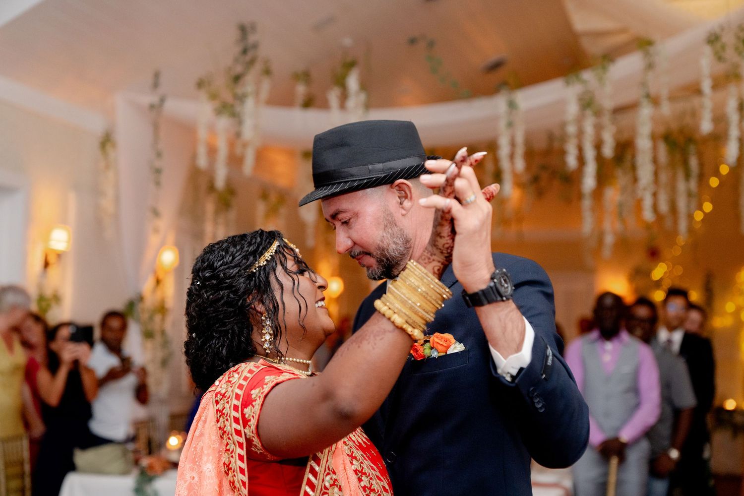 Wedding couple shares joyful dance moments during their reception celebration.