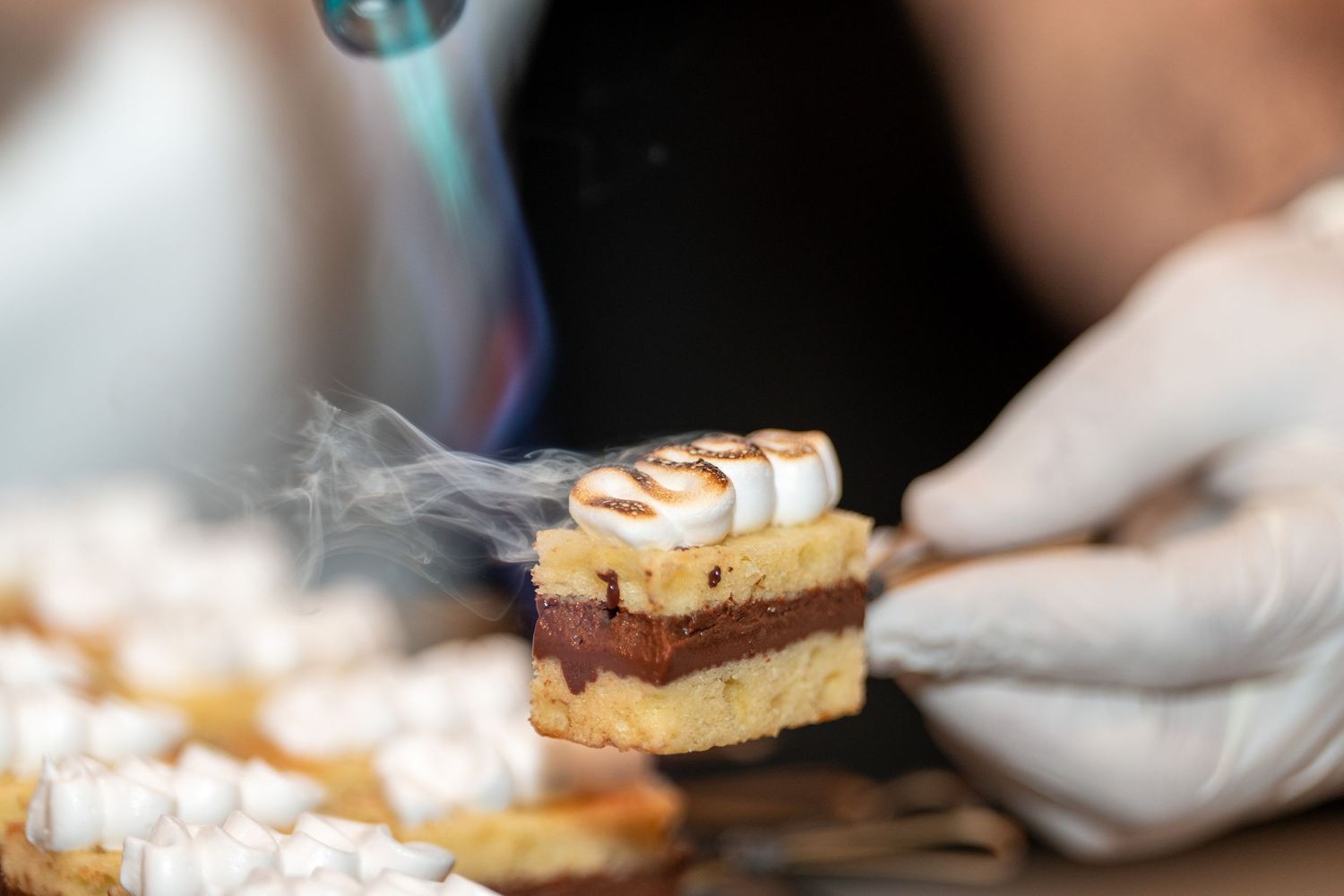 Dessert plates being served with delicate pastries and garnishes.
