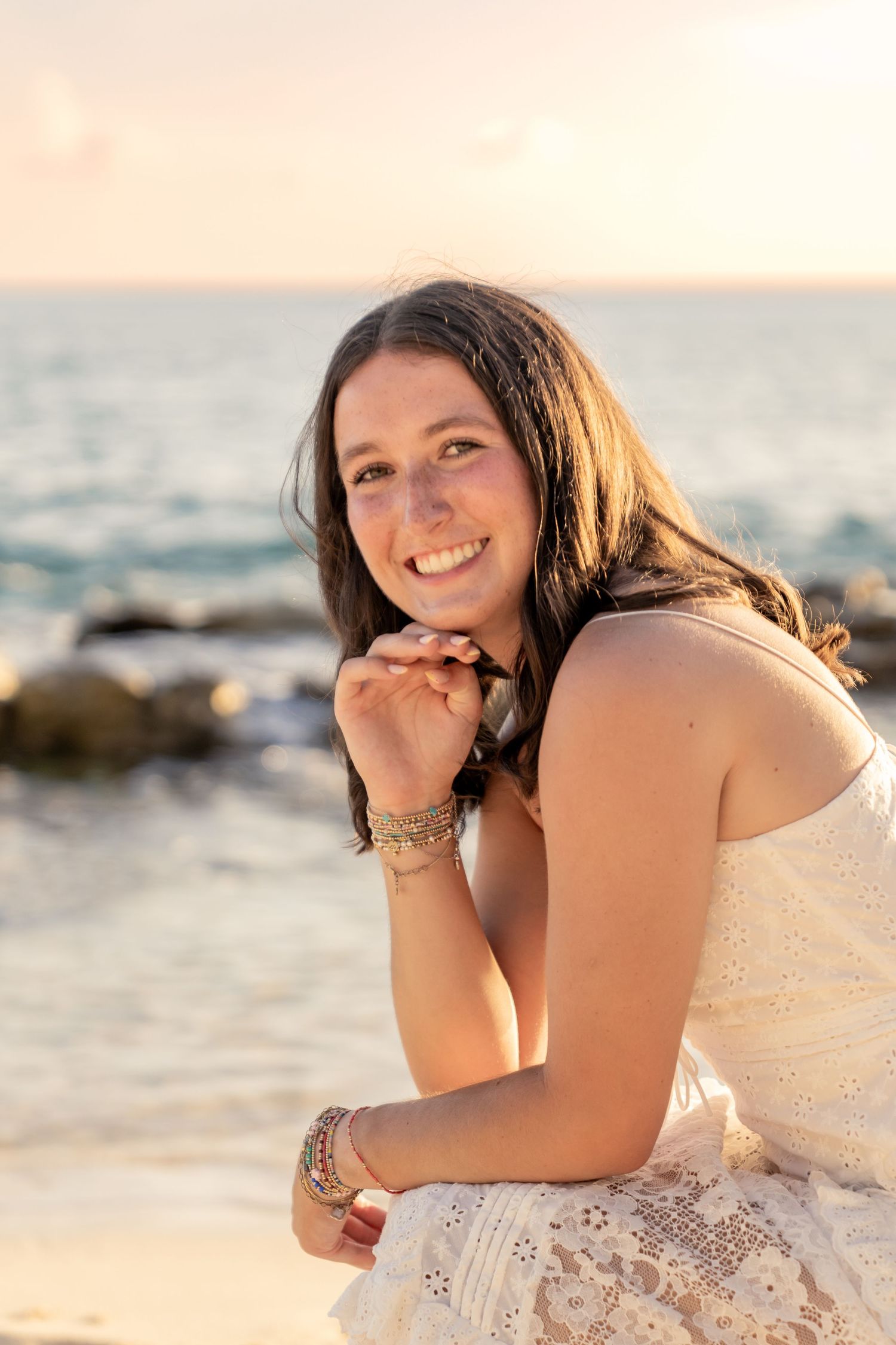 Relaxed beach portraits with natural lighting and ocean backdrop.