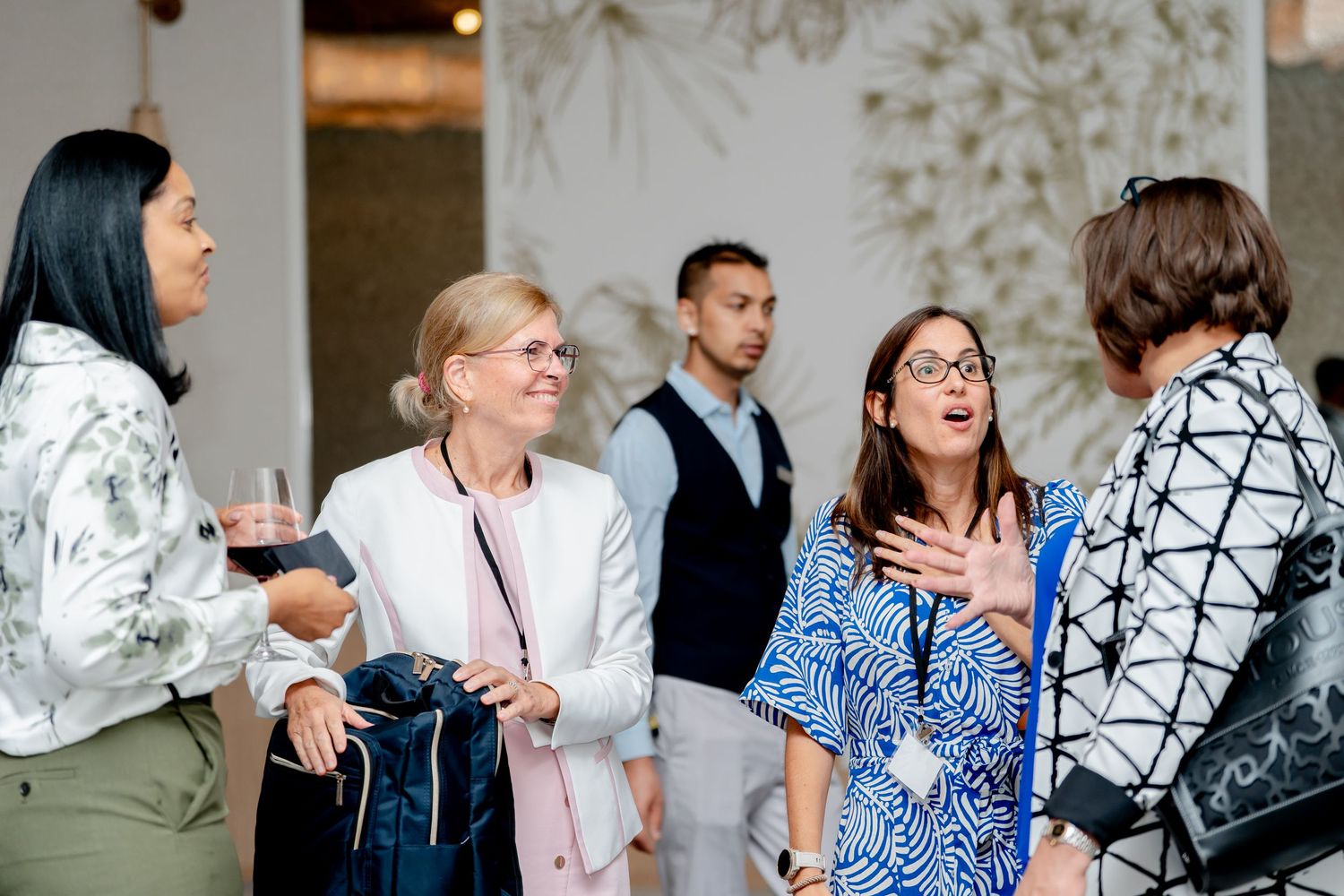 Attendees network and socialize during a business conference break.
