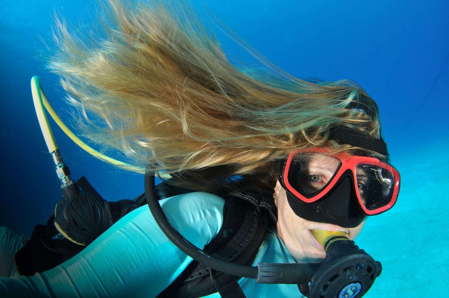 Underwater diver exploring vibrant coral reef in crystal clear tropical waters.