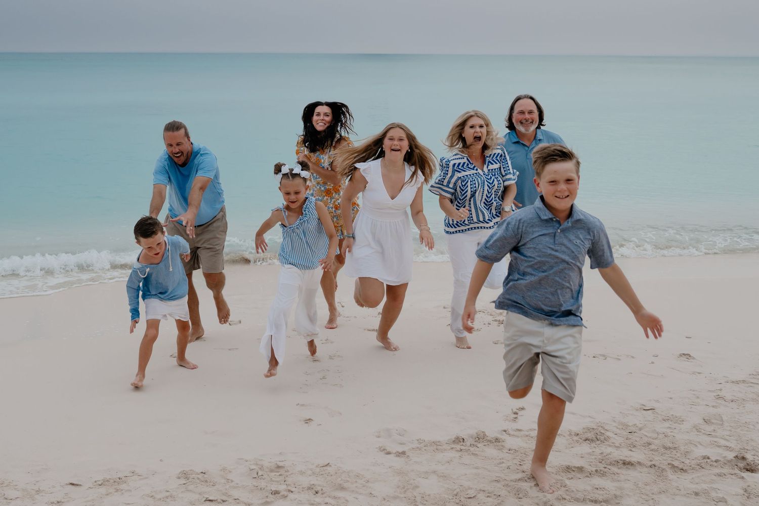 Dynamic beach photography sequence showing family members running and playing by the ocean.