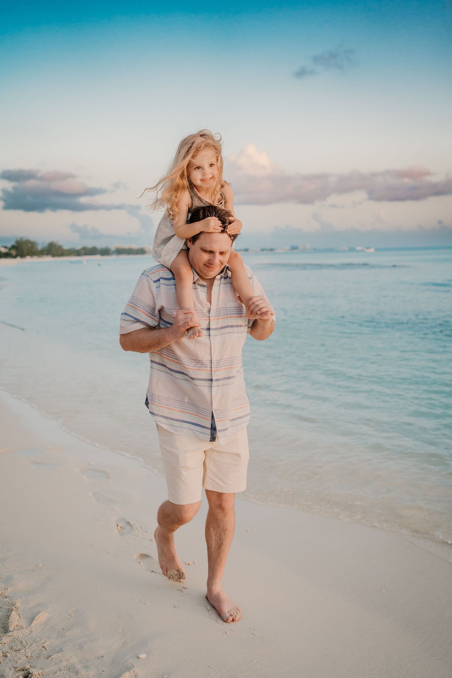 Candid beach photography showing natural moments of joy along the shoreline.