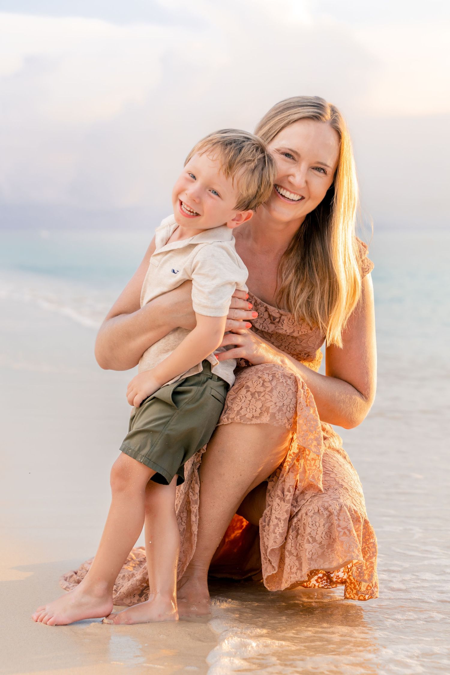Joyful beach portrait with gentle waves and golden sunset light creating a warm atmosphere.