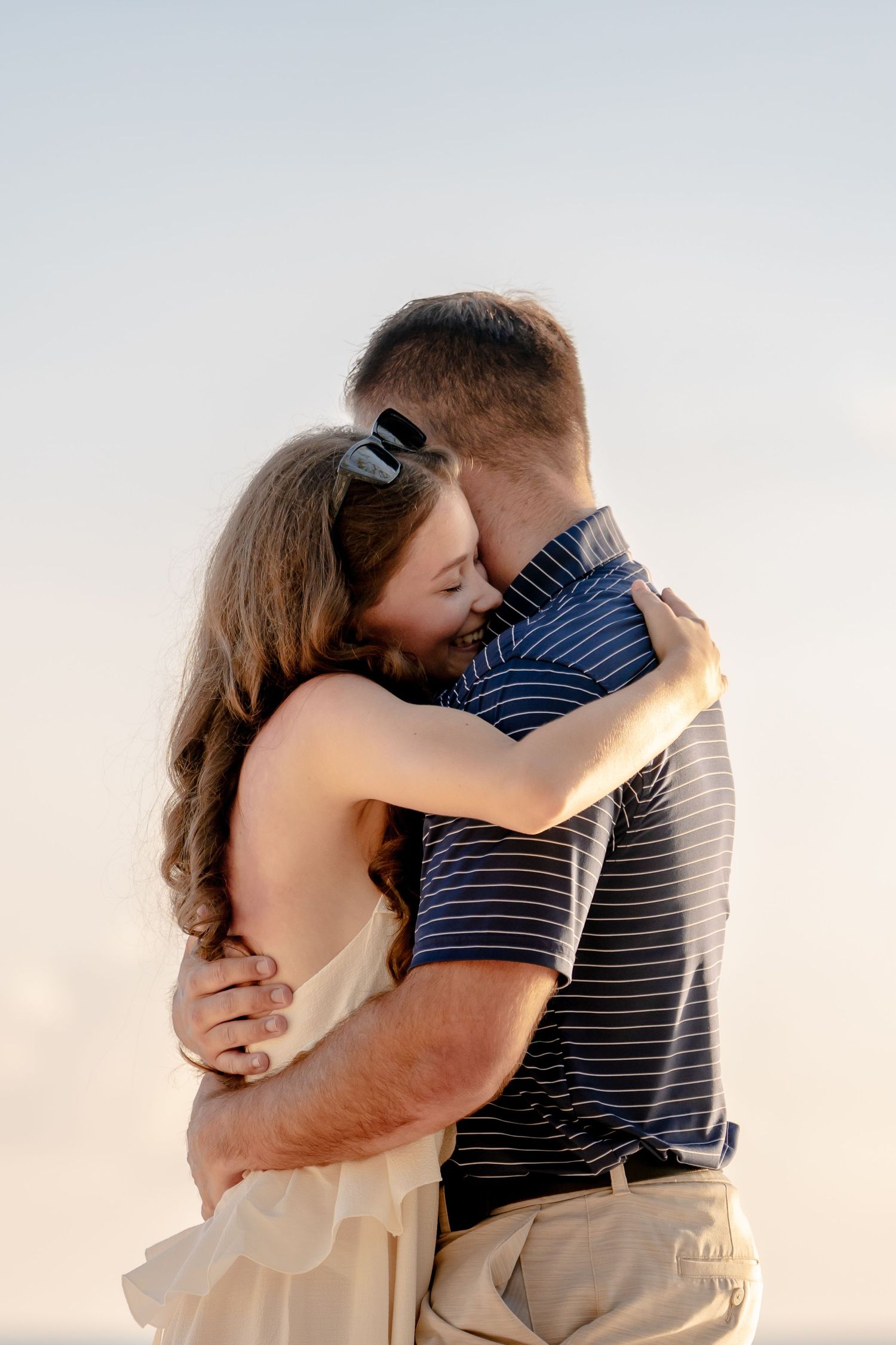 Emotional embrace captured during a sunset photo session.