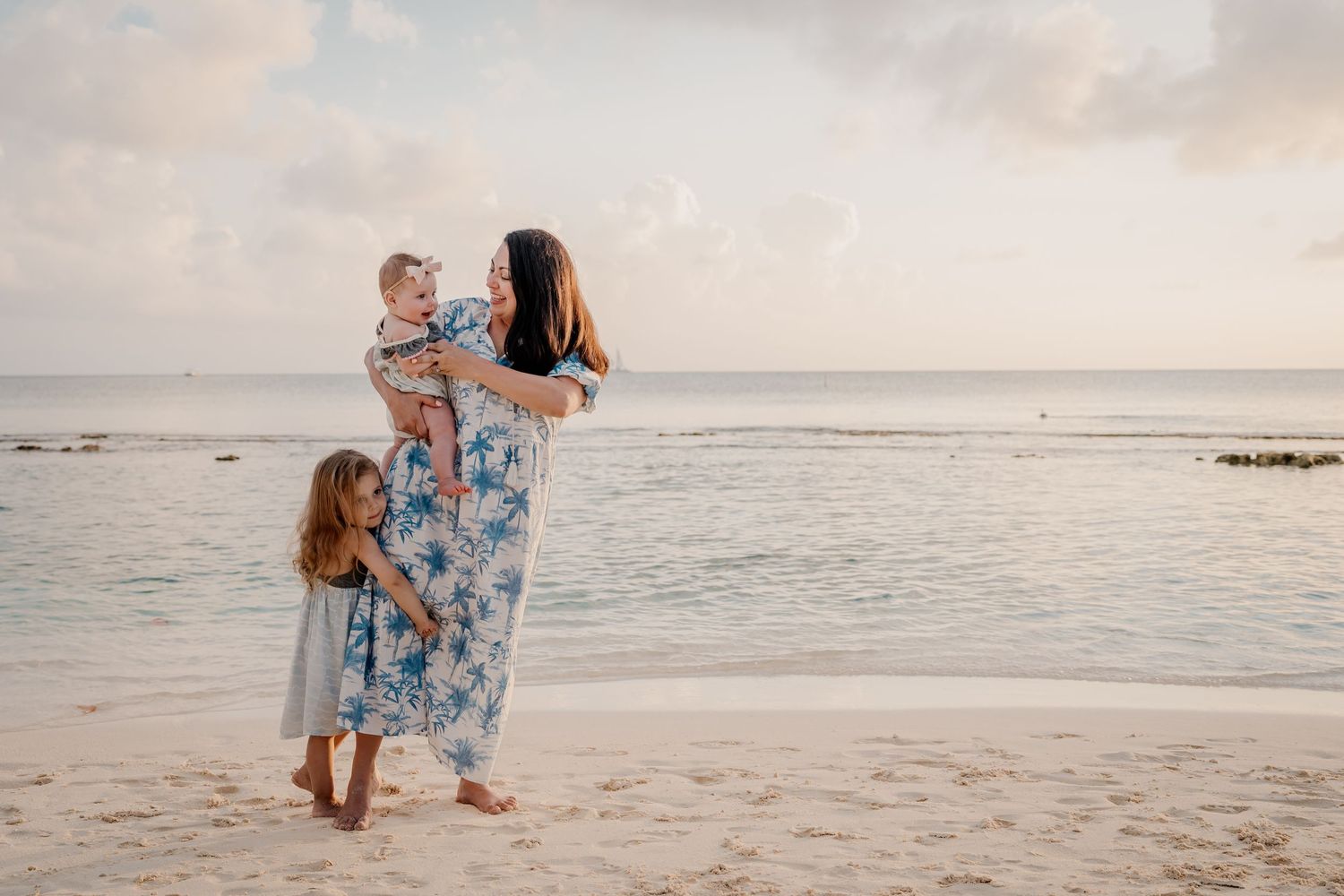 Joyful moments captured between couples playing on beach at sunset.