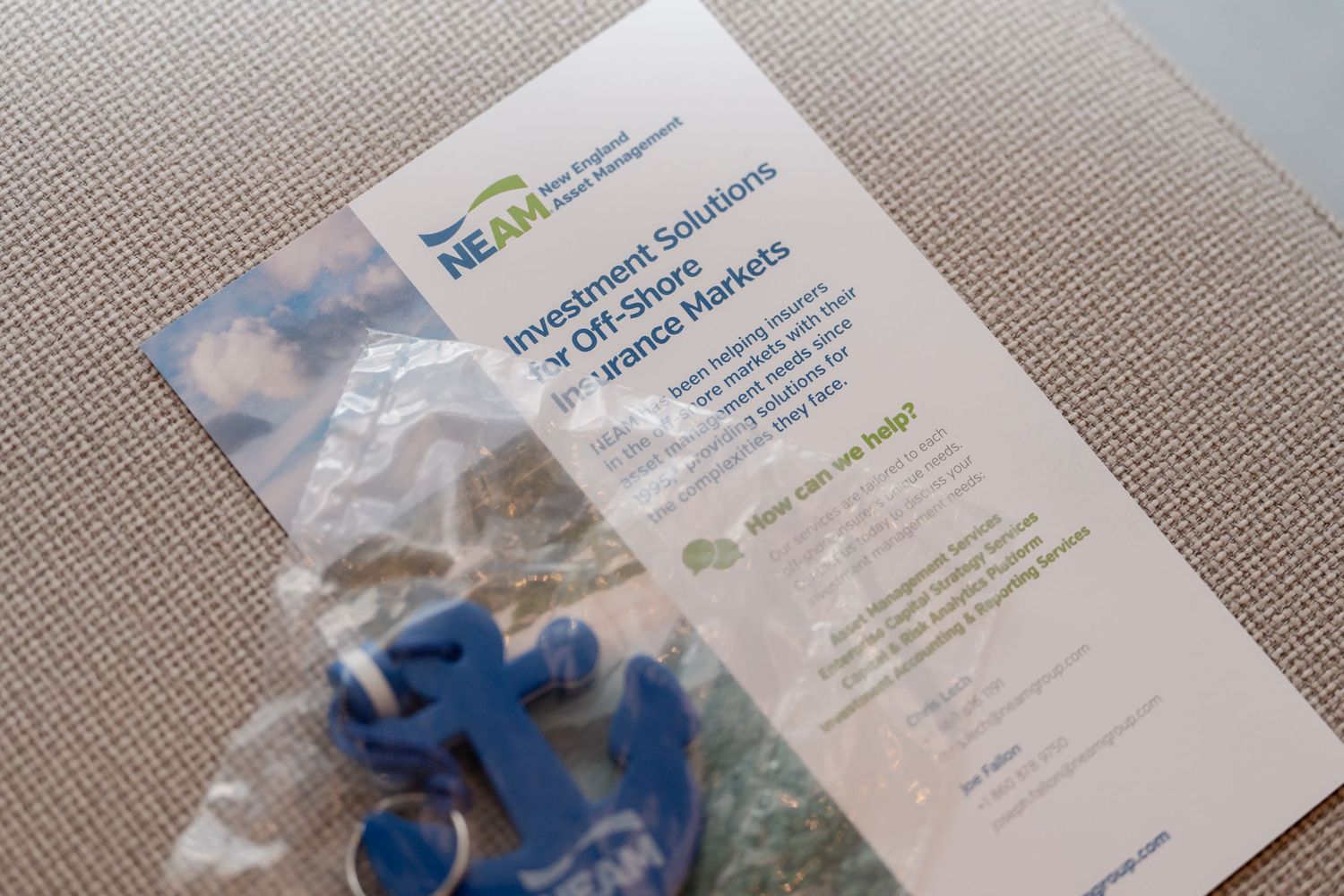 Conference materials and name badges laid out on a gray textured surface.