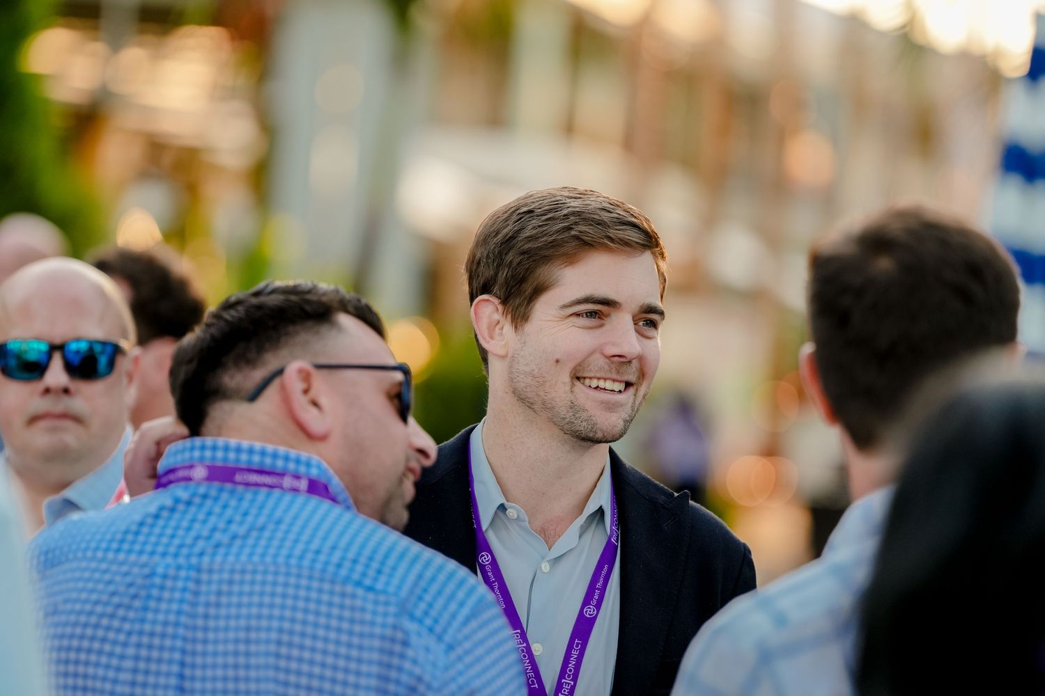 Crowd of business professionals networking at an outdoor event.