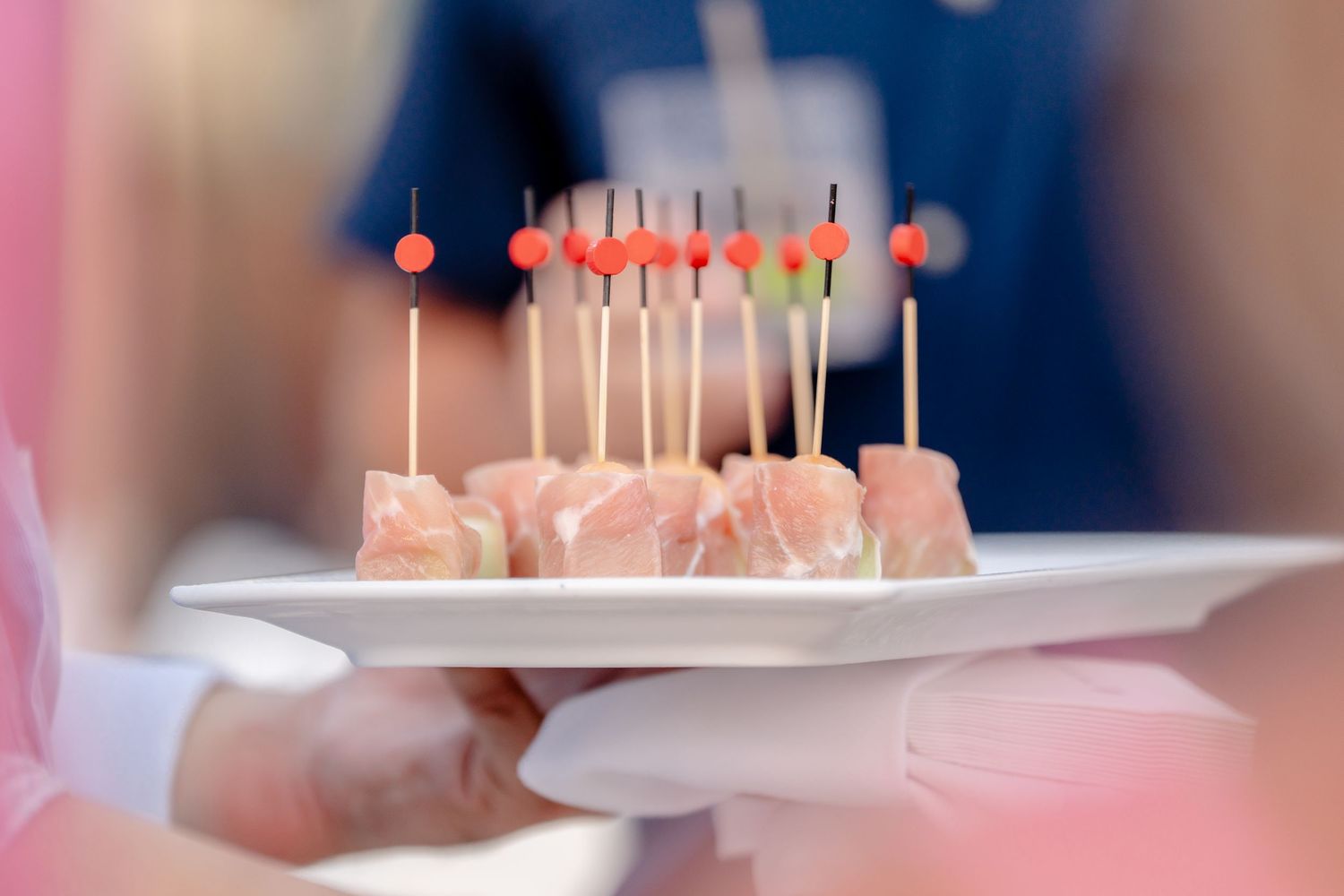 Birthday cake with lit candles being presented at a celebration party.