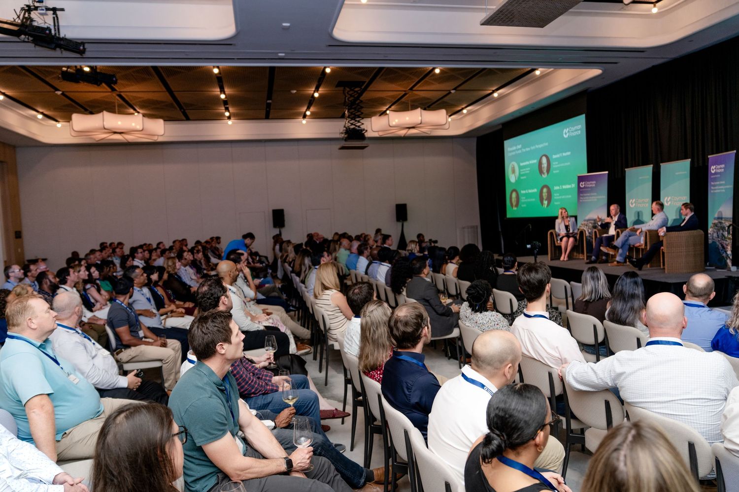 Large conference room filled with attendees watching presentation on screen.