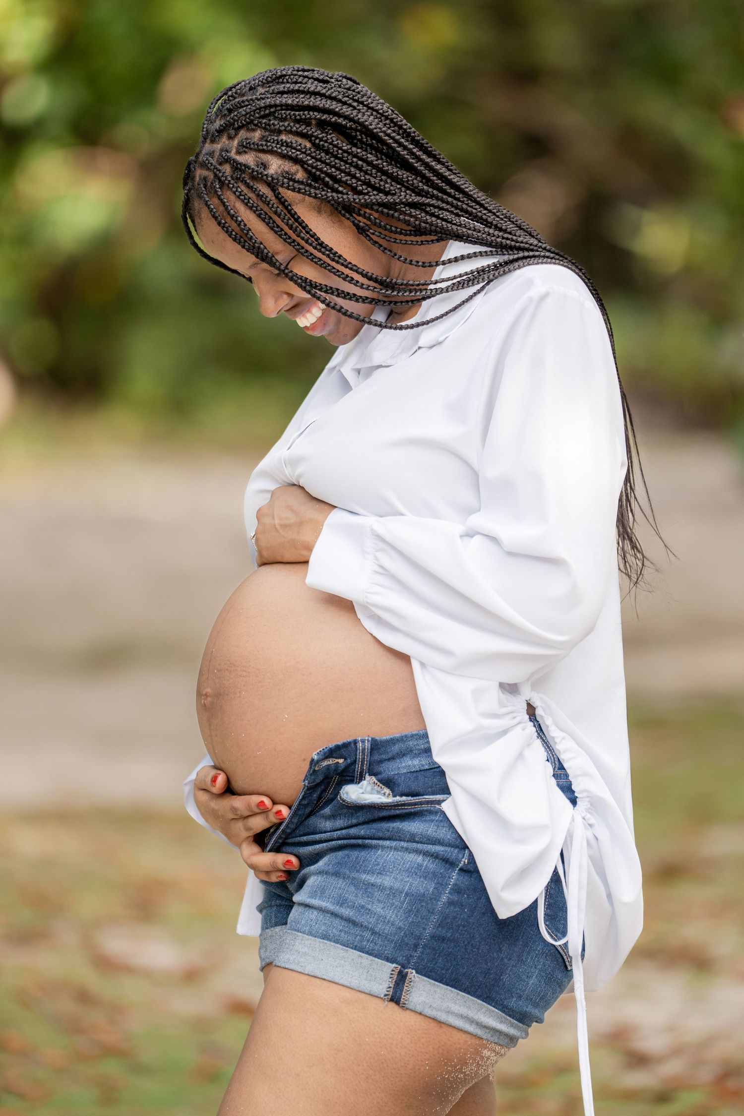 A series of maternity photos showing a pregnant person in denim shorts and white top against a natural background.