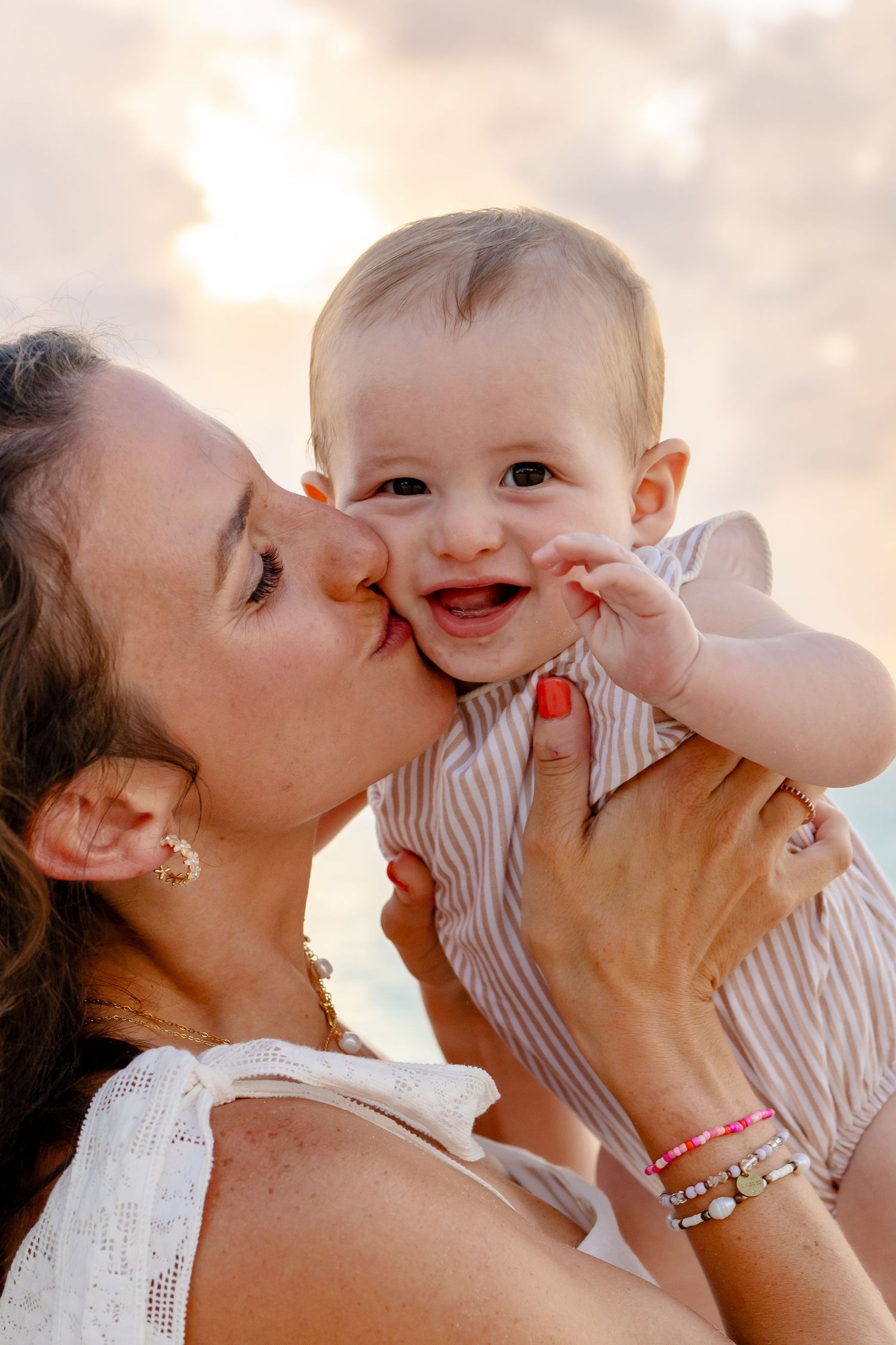 Sweet moments of affection shared between parent and child on the beach.