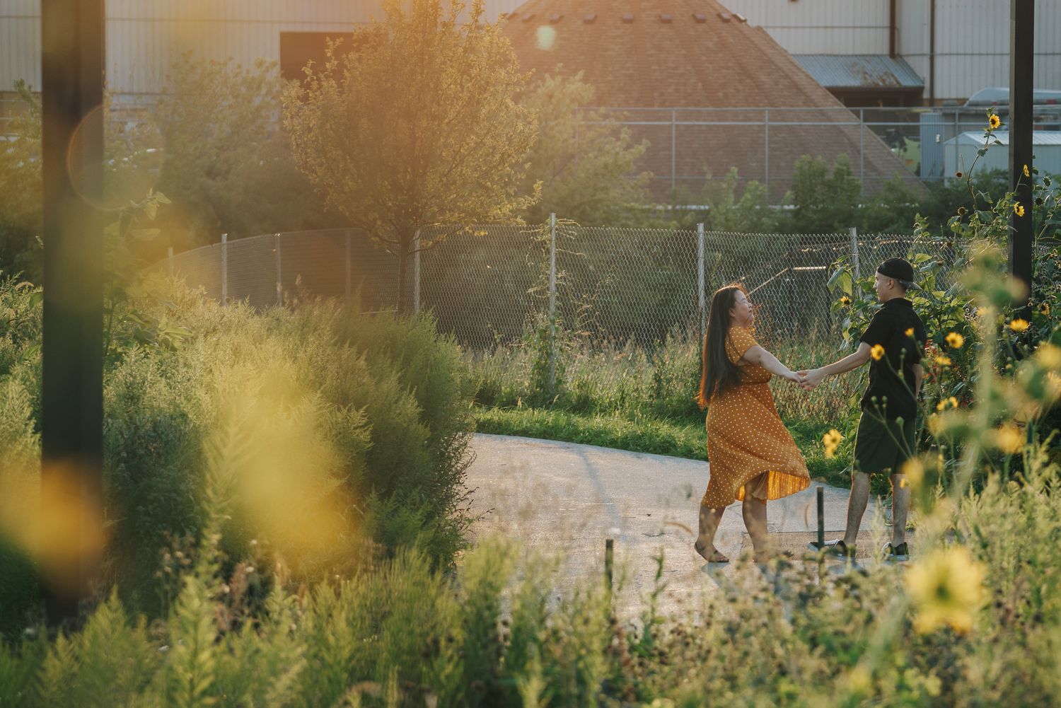 Engagement session at a park embracing freedom like the wildflowers around the dancing couple.