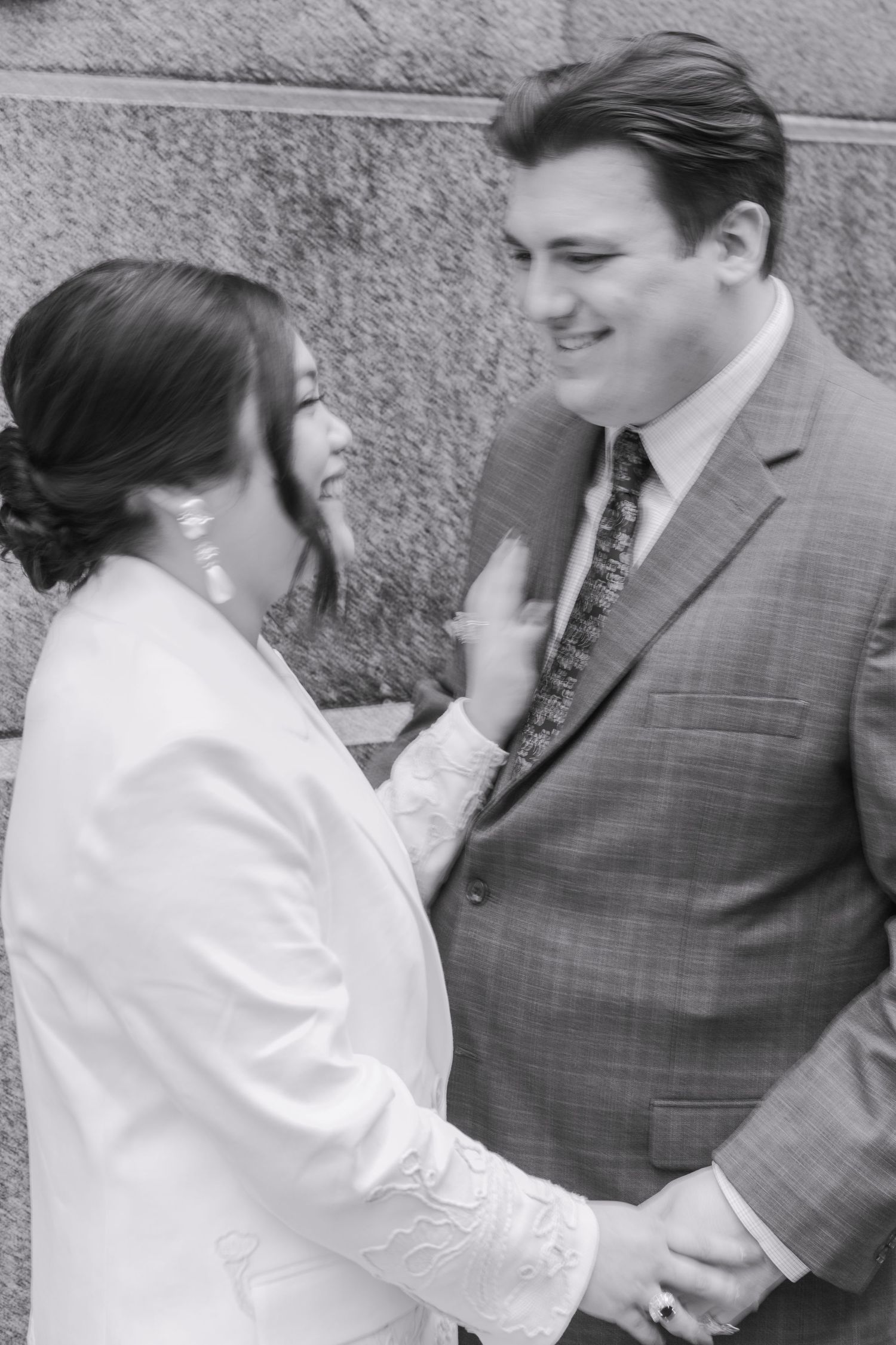 Black and white courthouse wedding capturing raw emotional laughter and joy.