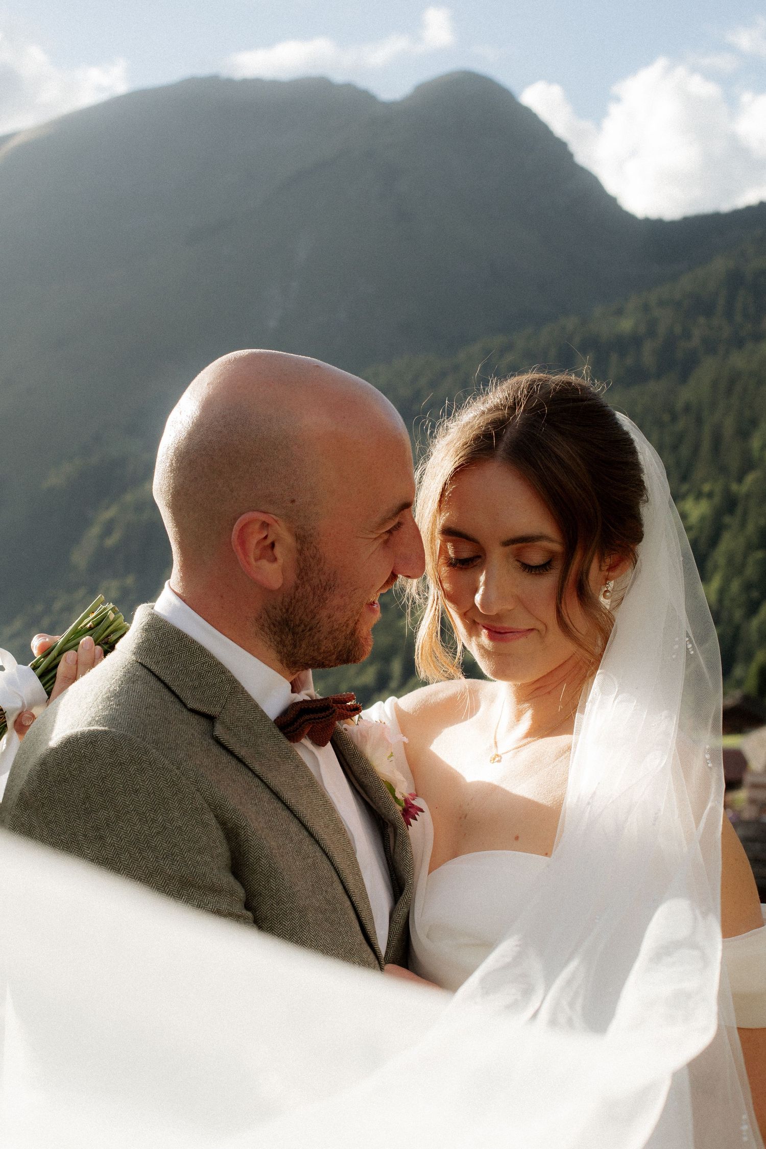 Morzine Wedding photographer captures intimate sunset wedding photos with a mountain backdrop.Candid timeless documentary style photography