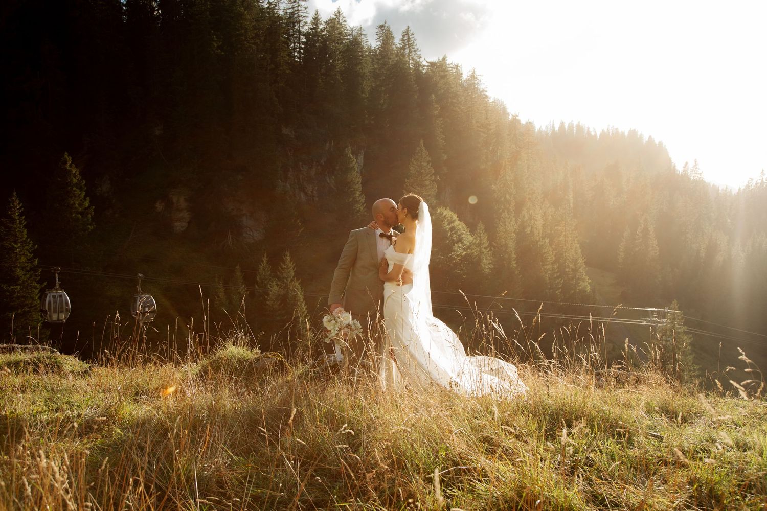 Morzine Wedding photographer captures stunning sunset wedding photos with a mountain backdrop.Candid timeless documentary style photos
