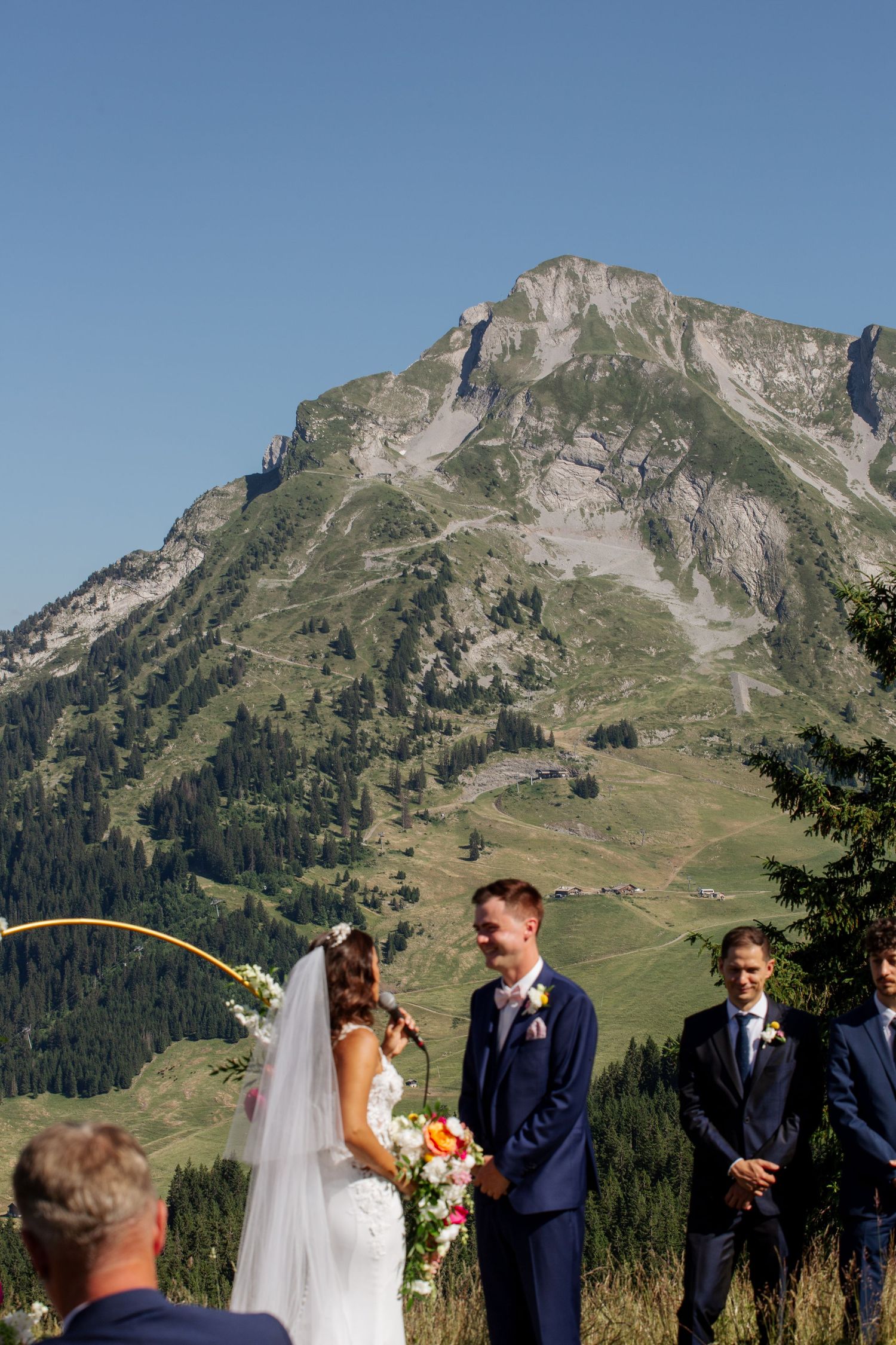 Morzine Wedding Photographer captures wedding ceremony photo at La Clusaz Wedding venue. French Mountain Wedding photographer. Outdoor Bride