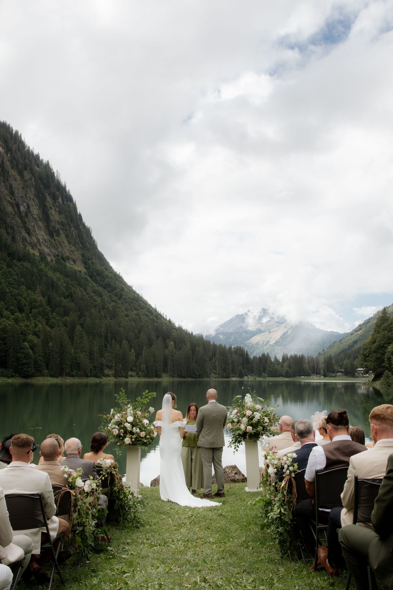 Morzine Wedding photographer captures outdoor wedding cermeony photo on Lac Montriond. Candid timeless documentary style photography.