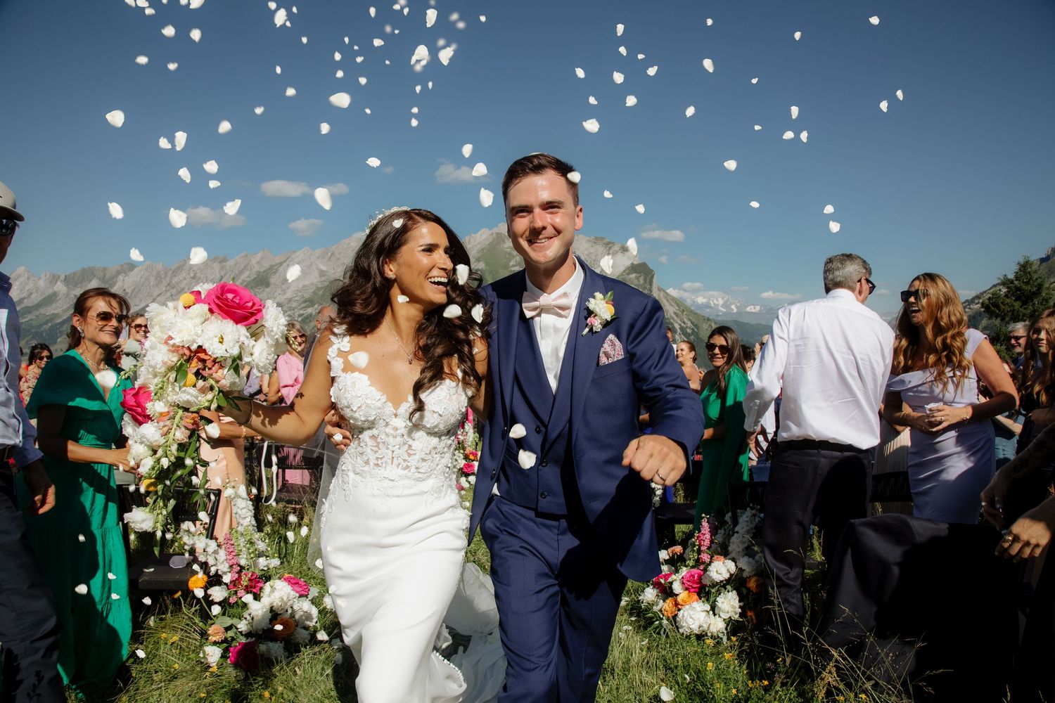 Morzine Wedding Photographer captures fun confetti photo at La Clusaz Wedding venue. French Mountain Wedding photographer. Outdoor Bride