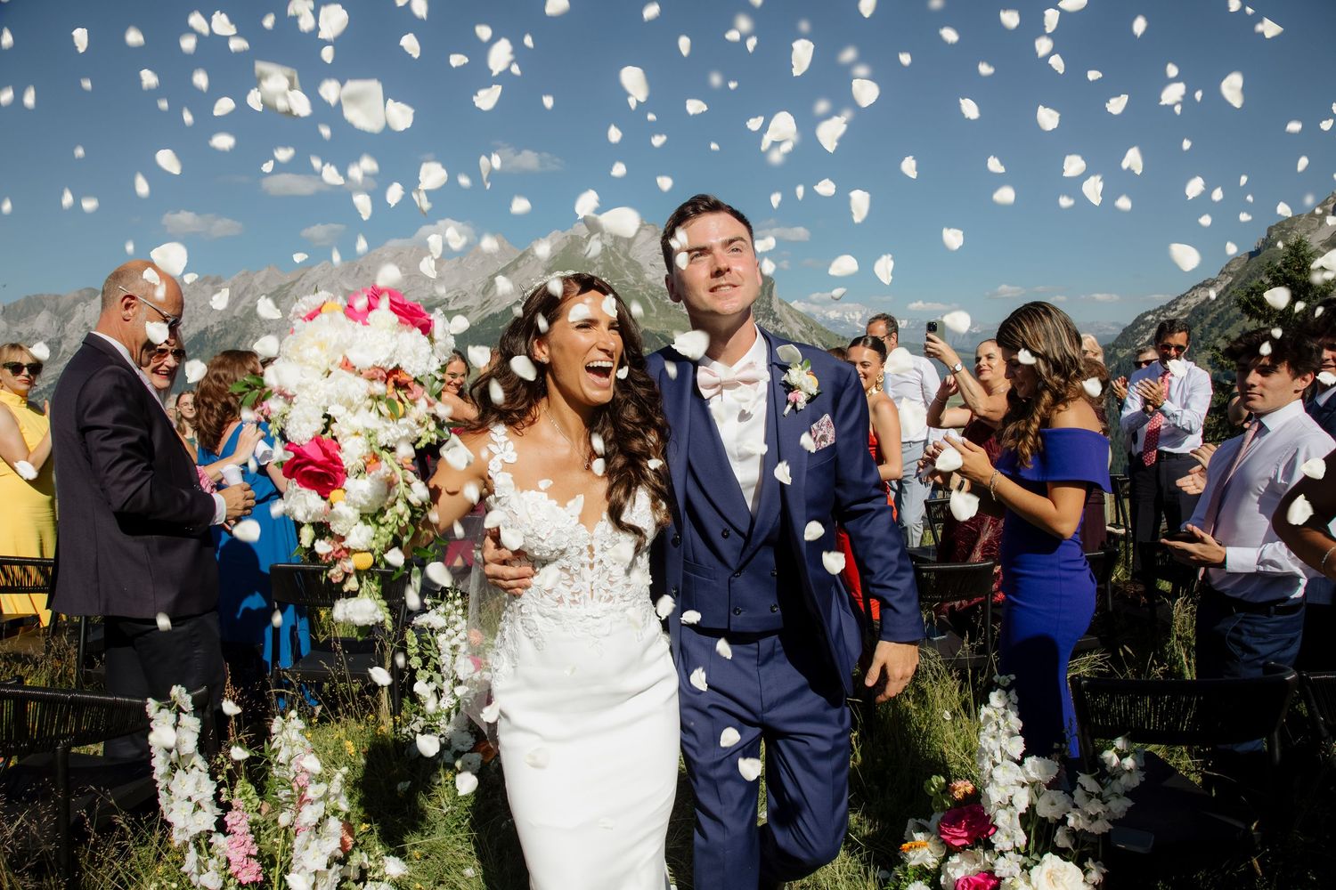 Morzine Wedding Photographer captures fun confetti photo at La Clusaz Wedding venue. French Mountain Wedding photographer. Outdoor Bride