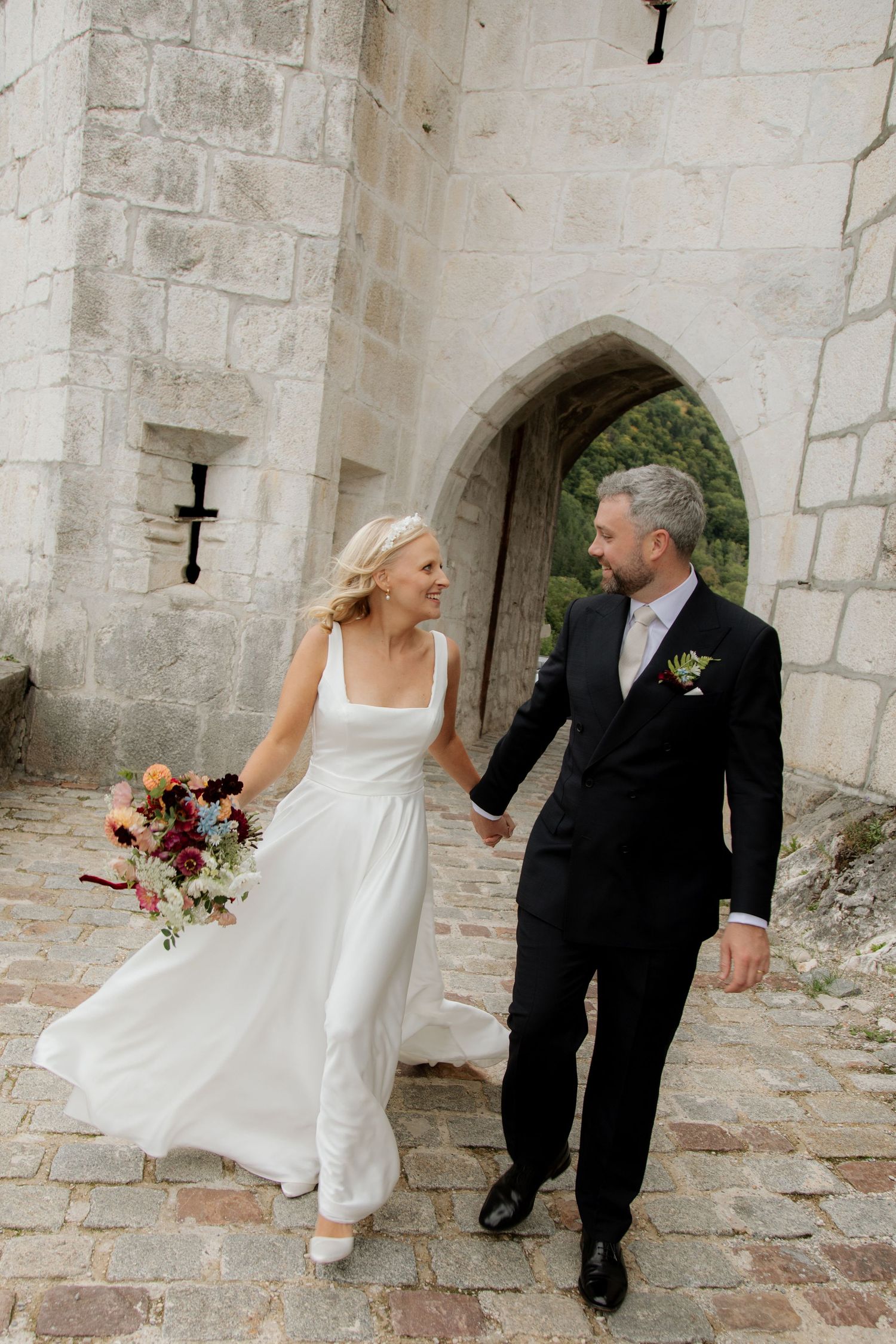 Morzine Wedding Photographer captures candid couples photo at a Annecy Chateau Wedding venue . Natural, honest & authentic storytelling.