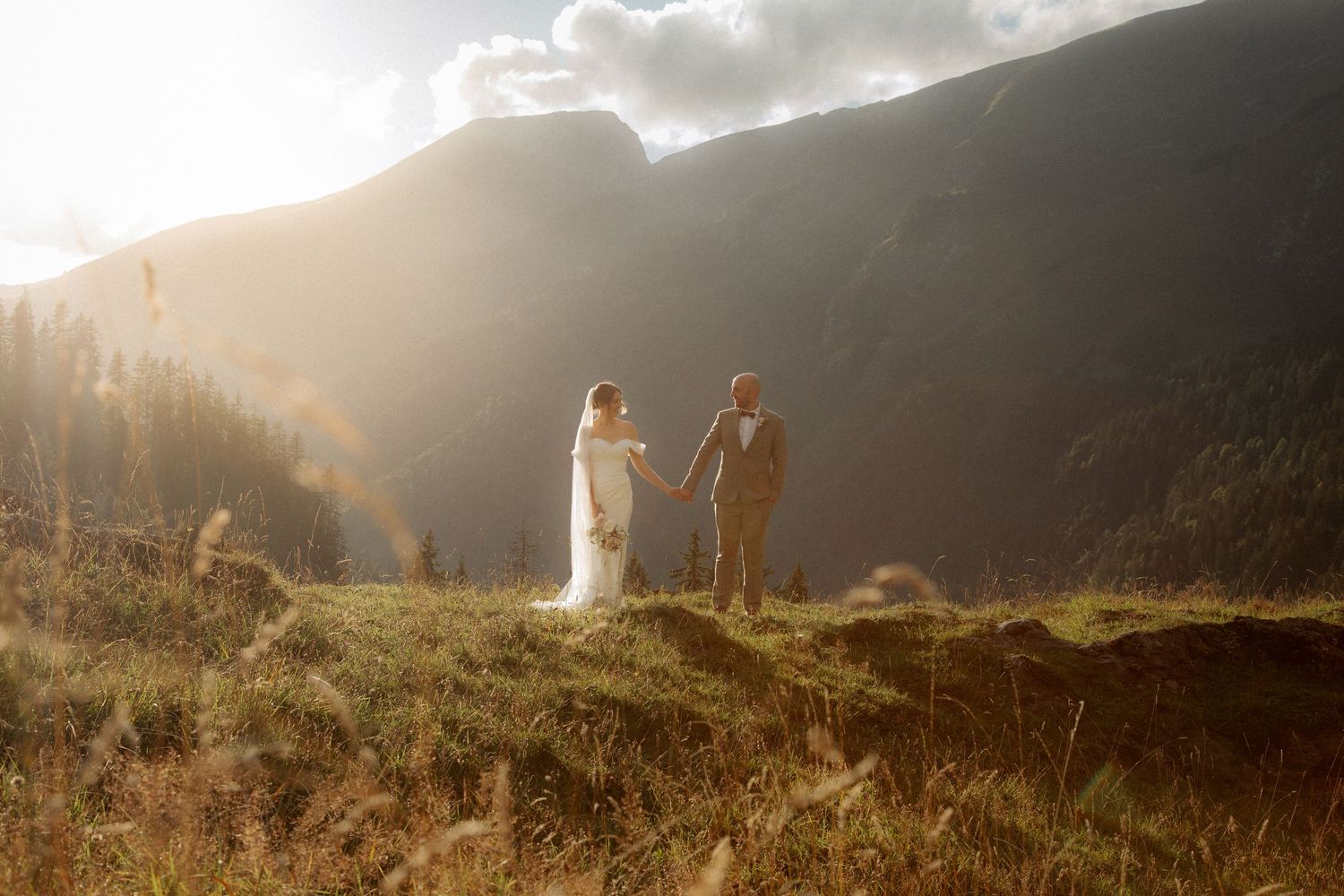 Morzine Wedding photographer captures stunning sunset wedding photos with a mountain backdrop.Candid timeless documentary style photos