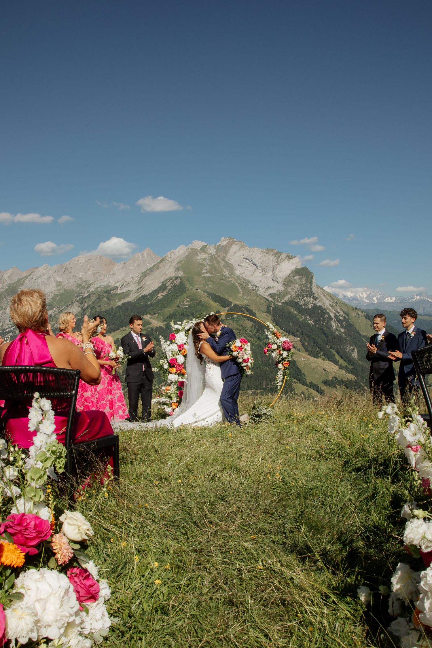 Morzine Wedding Photographer captures fun confetti photo at La Clusaz Wedding venue. French Mountain Wedding photographer. Outdoor Bride