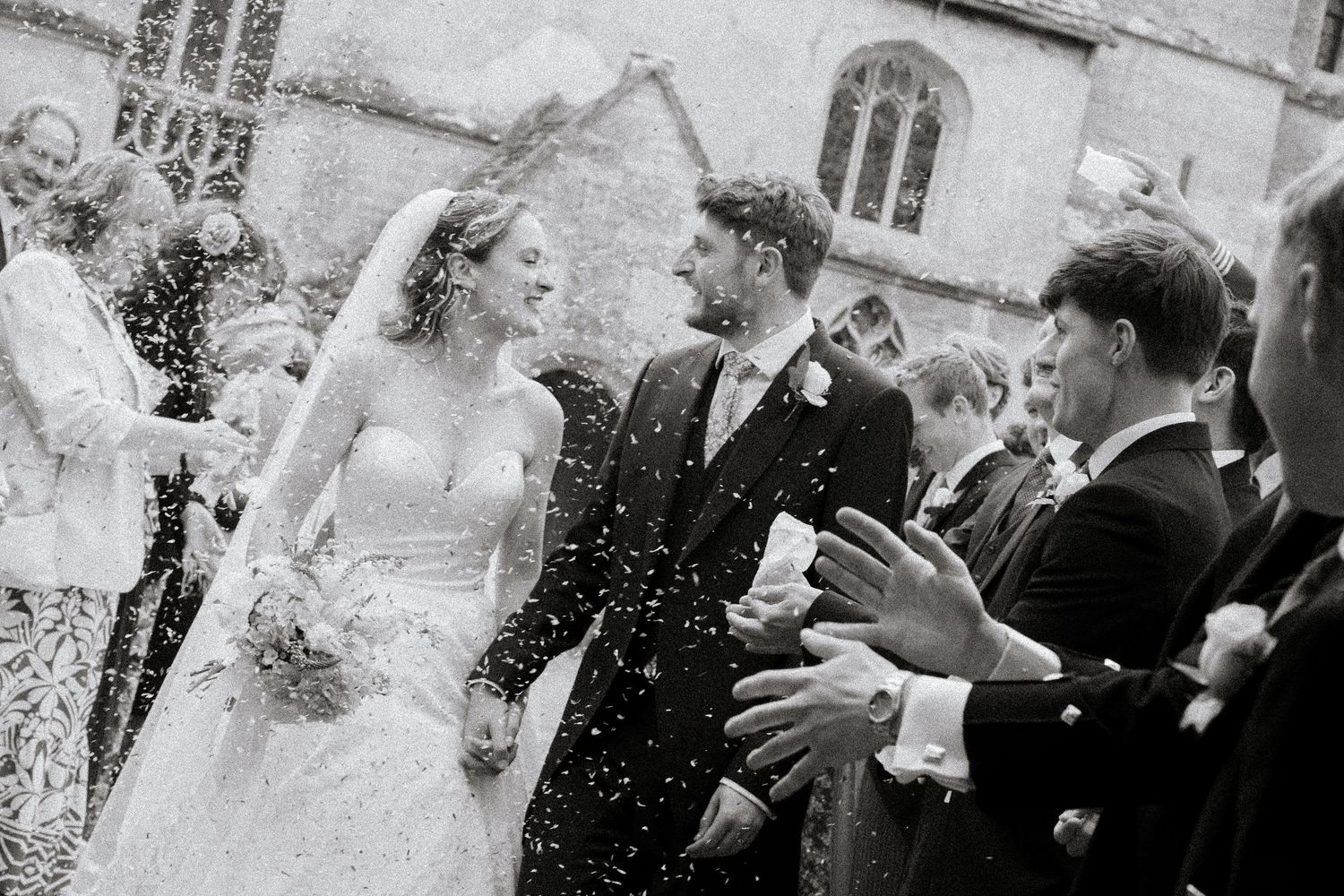 Documentary Style Cotswold Wedding Photographer captures wedding confetti at Gloucestershire Wedding Venue.Natural,candid and timeless photo