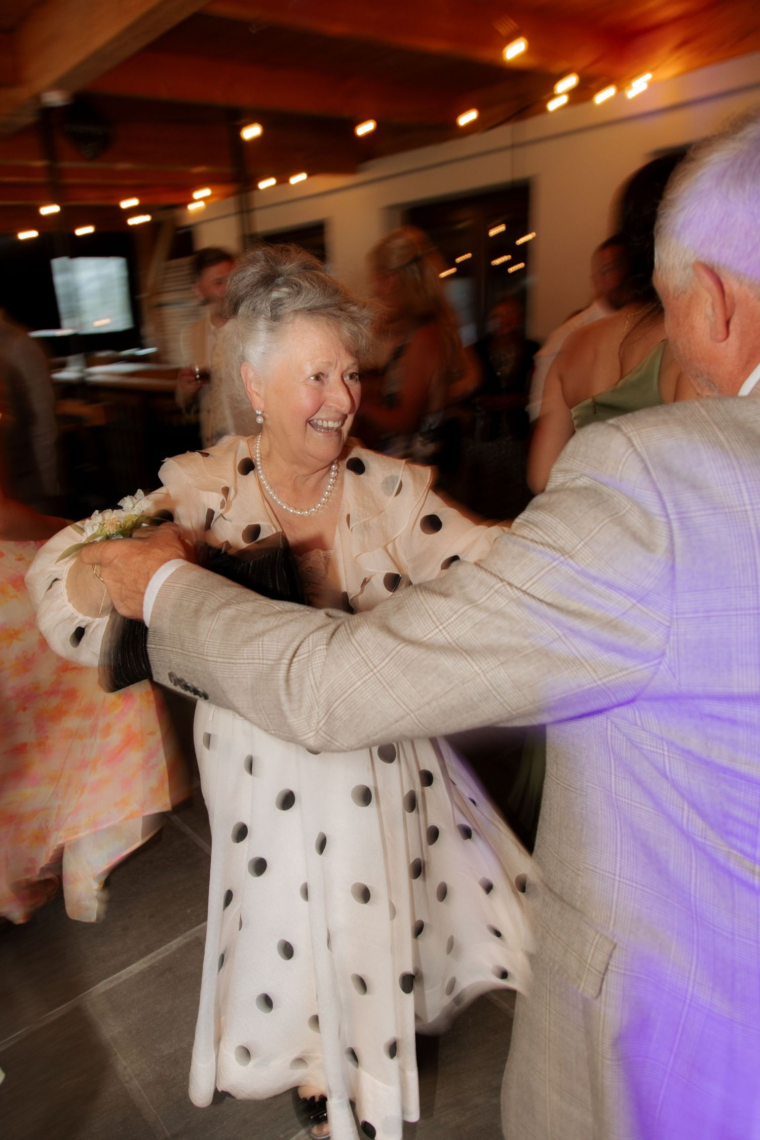 Morzine Wedding photographer captures wedding party dancing at montriond wedding venue. Candid timeless documentary style photos.Flash photo