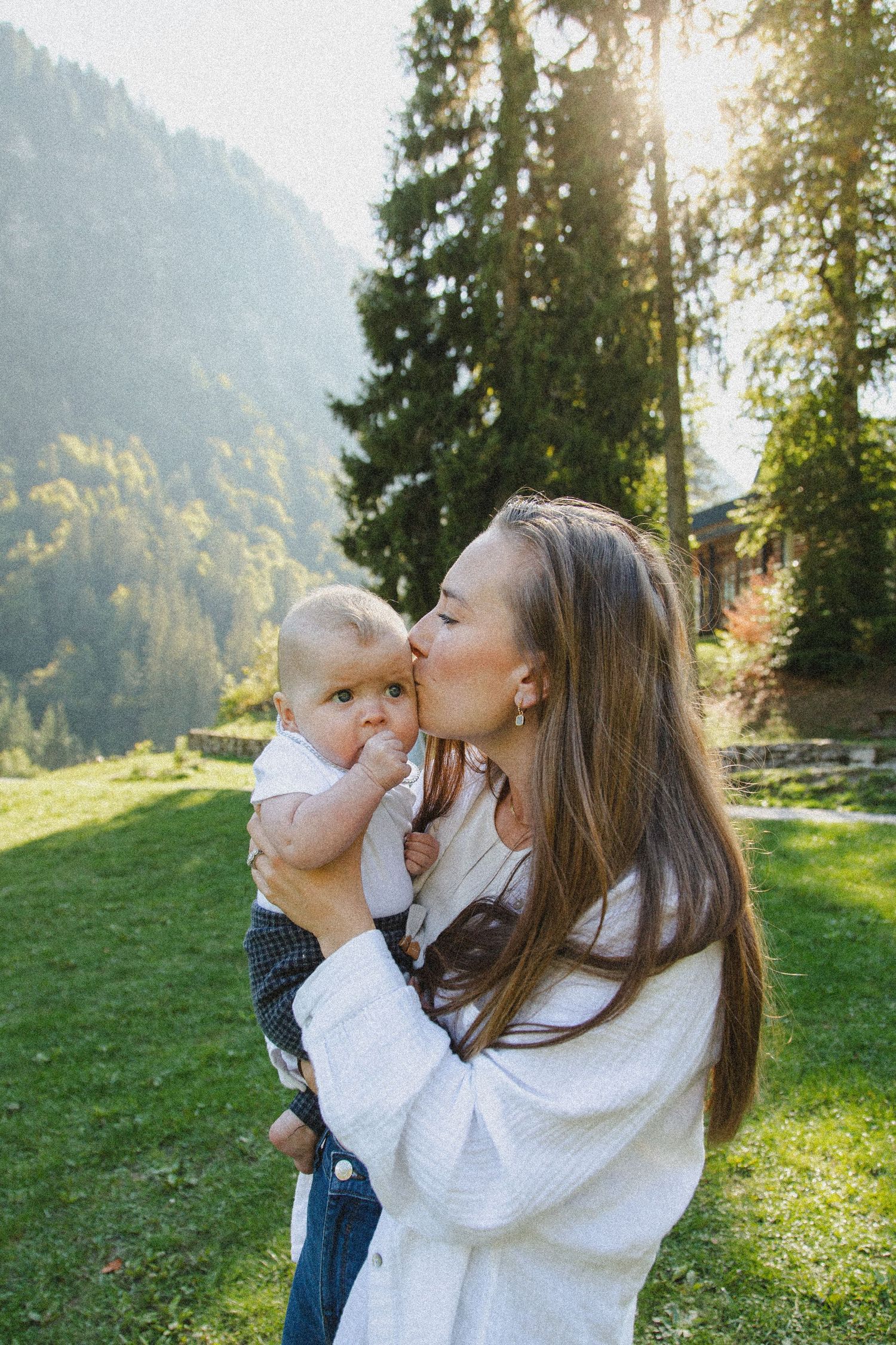 Outdoor family photography session with a mountain backdrop. Captured by Morzine Family photographer. Natural family portraits in morzine