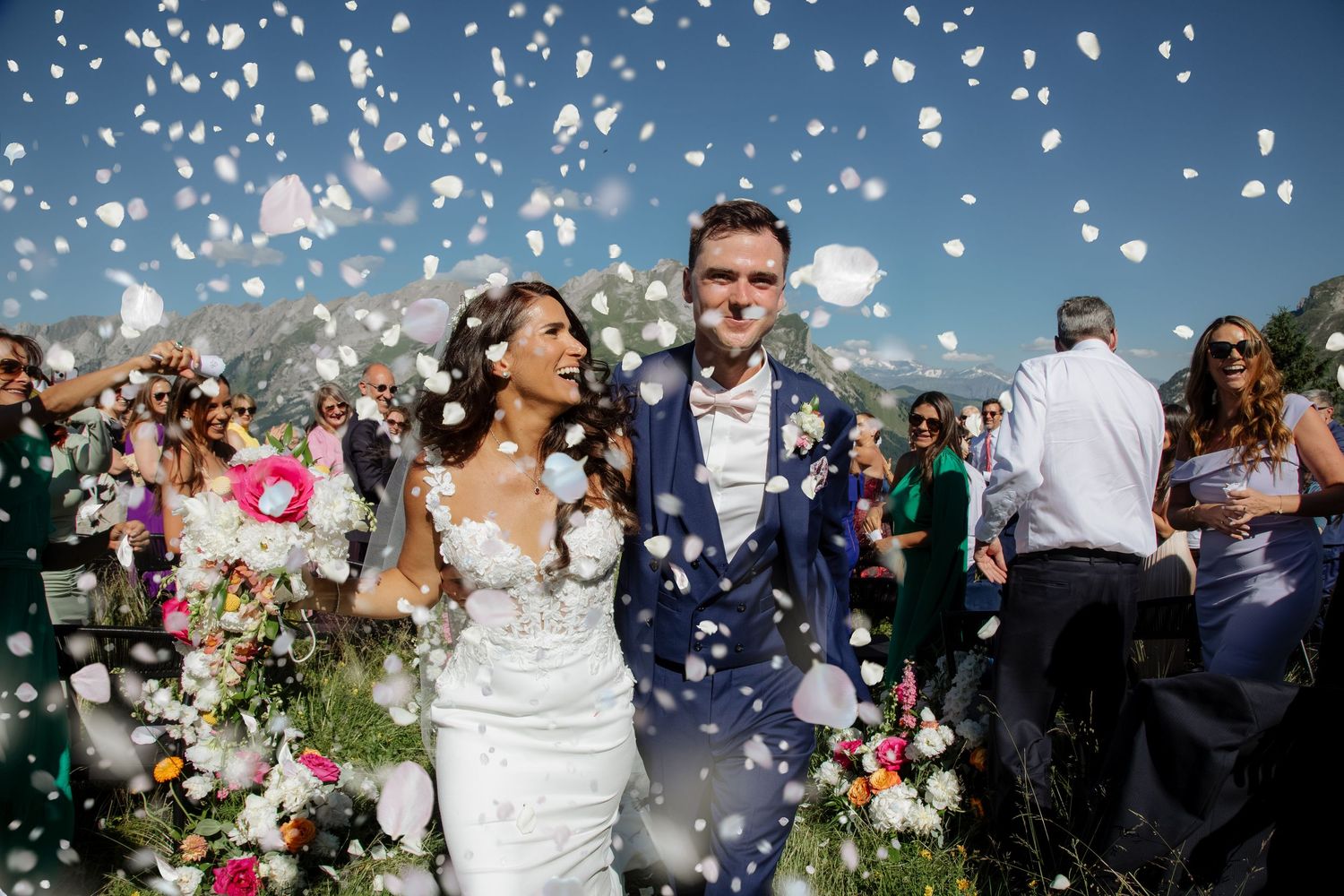 Morzine Wedding Photographer captures fun confetti photo at La Clusaz Wedding venue. French Mountain Wedding photographer. Outdoor Bride