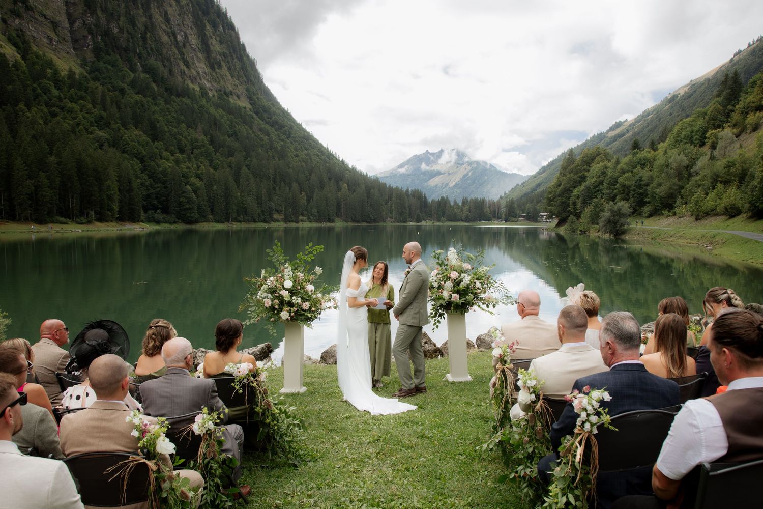 Morzine Wedding photographer captures outdoor wedding cermeony photo on Lac Montriond. Candid timeless documentary style photography.