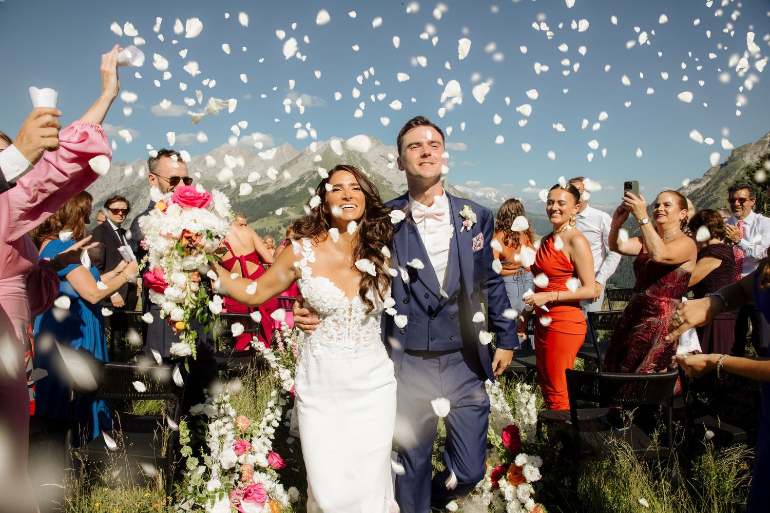 Morzine Wedding Photographer captures fun confetti photo at La Clusaz Wedding venue. French Mountain Wedding photographer. Outdoor Bride