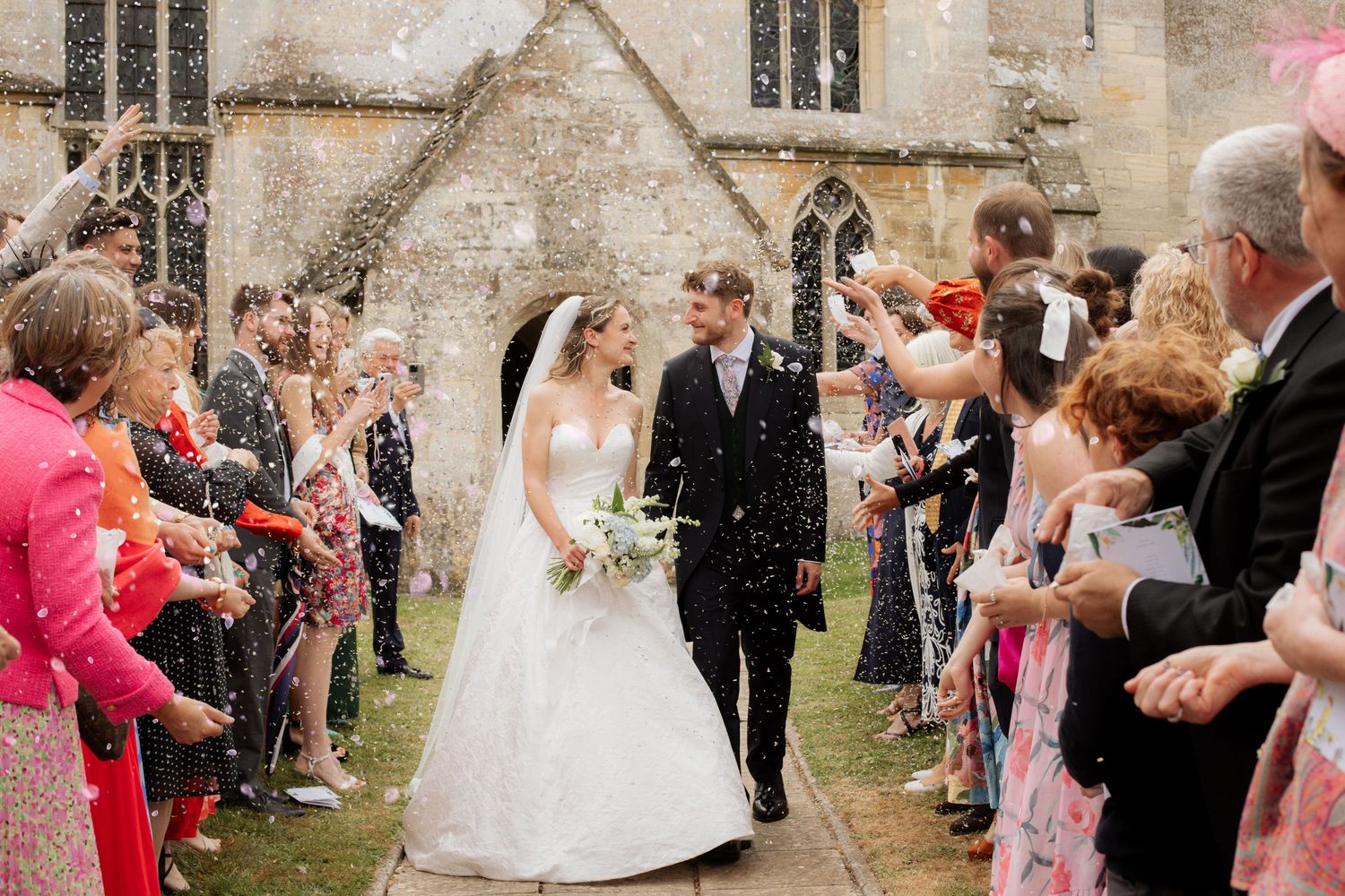 Candid Cotswold Wedding Photographer captures confetti at Gloucestershire Wedding Venue. Natural, candid and timeless photography, UK
