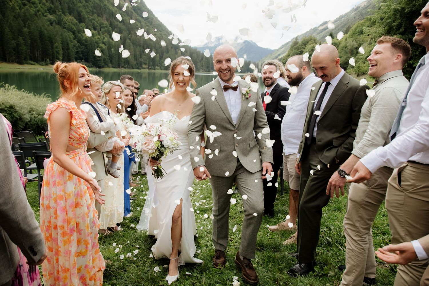 Morzine Wedding photographer captures outdoor wedding confetti photos on Lac Montriond. Candid timeless documentary style photography.