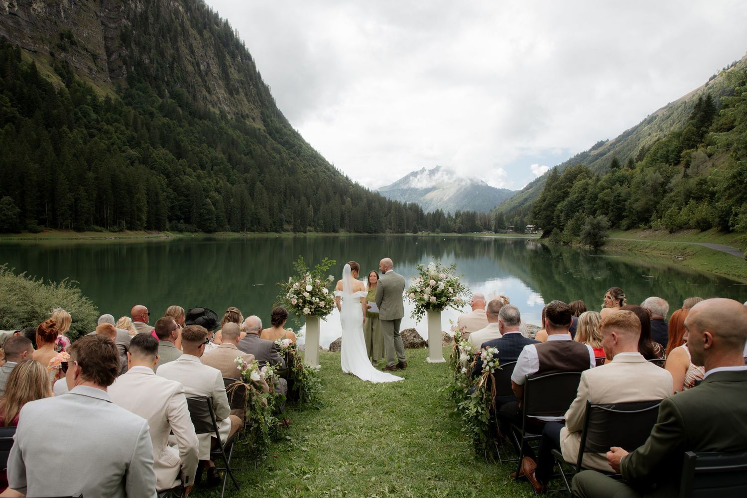 Morzine Wedding photographer captures outdoor wedding cermeony photo on Lac Montriond. Candid timeless documentary style photography.
